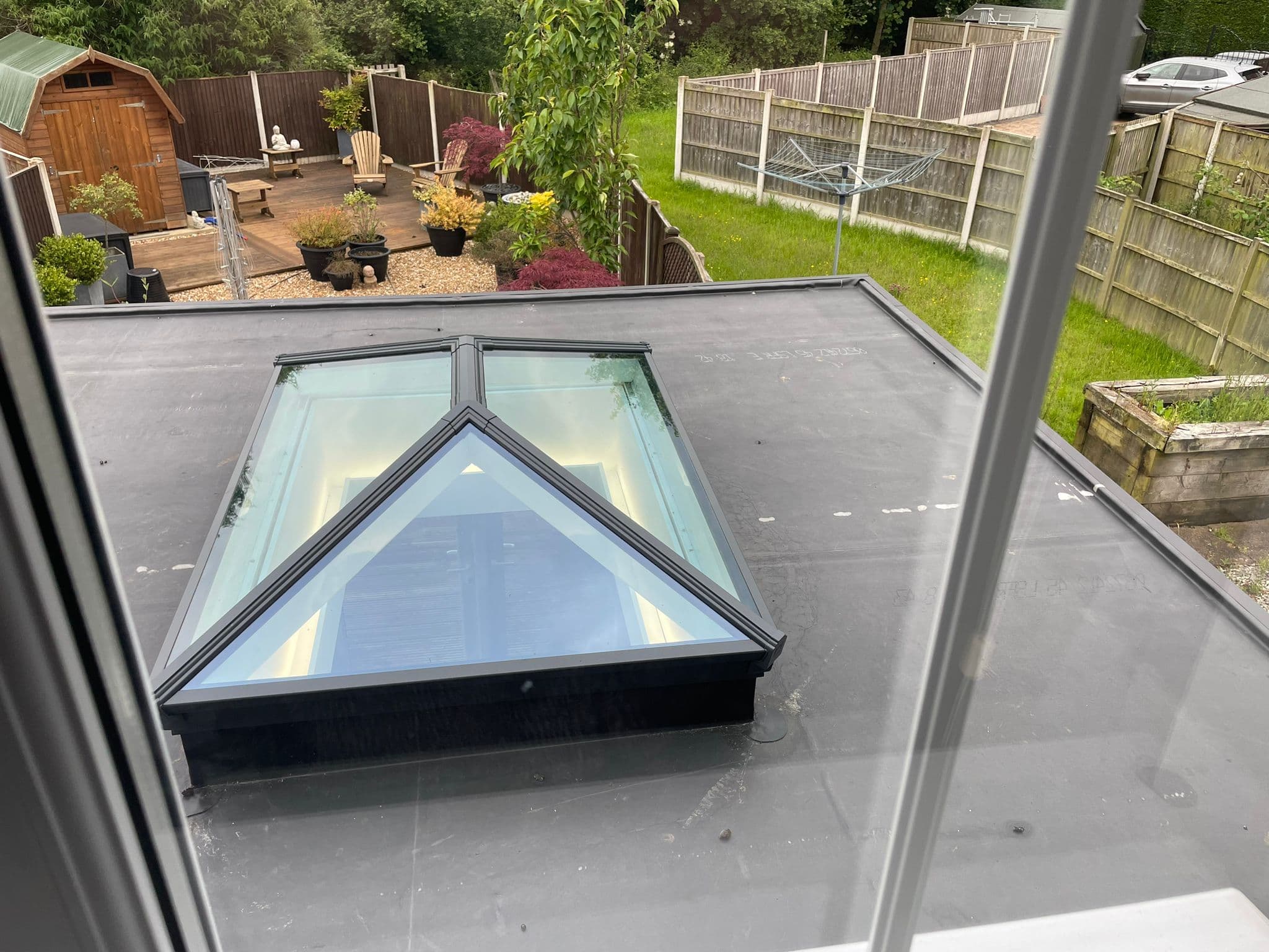 Pyramidal roof lantern set into a flat rubber roof