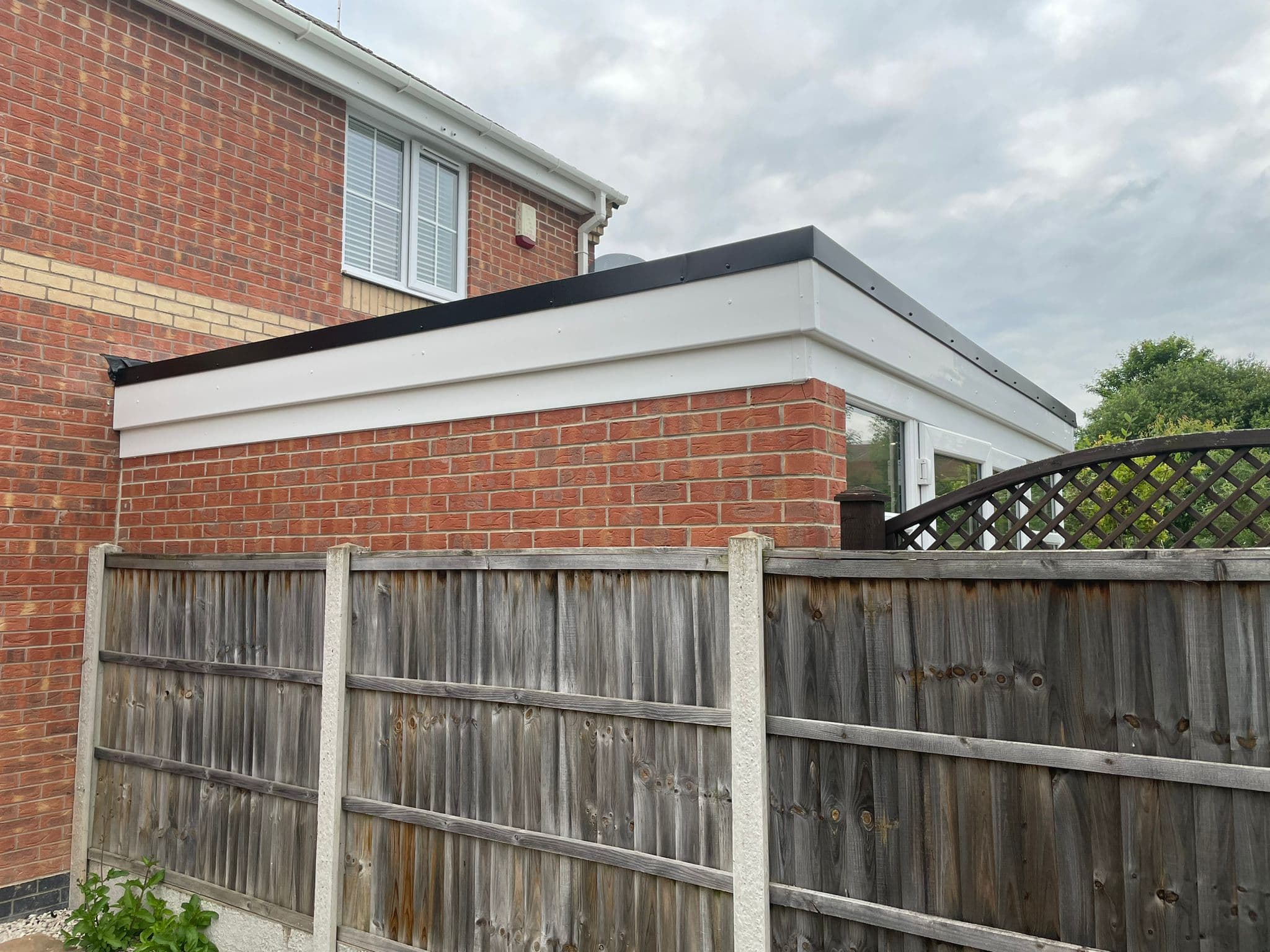 White UPVC fascia and soffit on a flat-roofed extension
