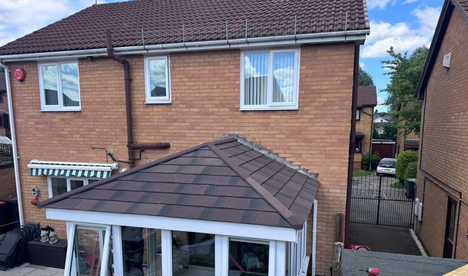 Sunlit conservatory with a new brown tiled warm roof fitted by WeatherTech Roofing