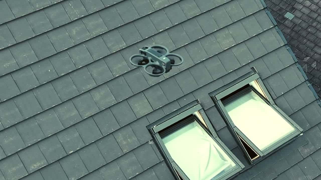 Drone hovering above a pitched roof during a WeatherTech roof survey