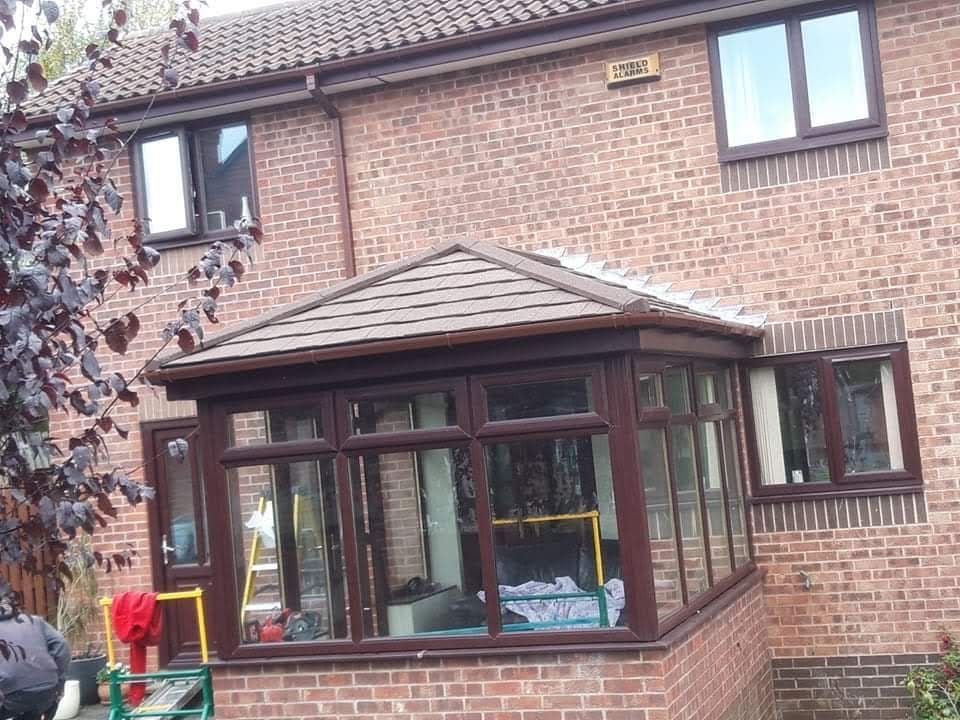 Tiled warm-roof conservatory with rosewood frames