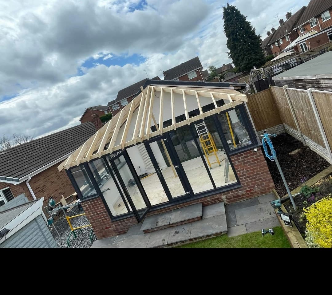 New timber roof structure built over the conservatory frames