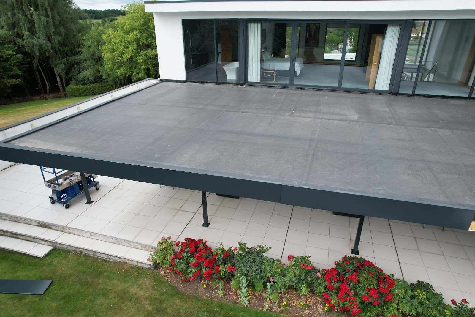 Modern grey flat roof by WeatherTech Roofing