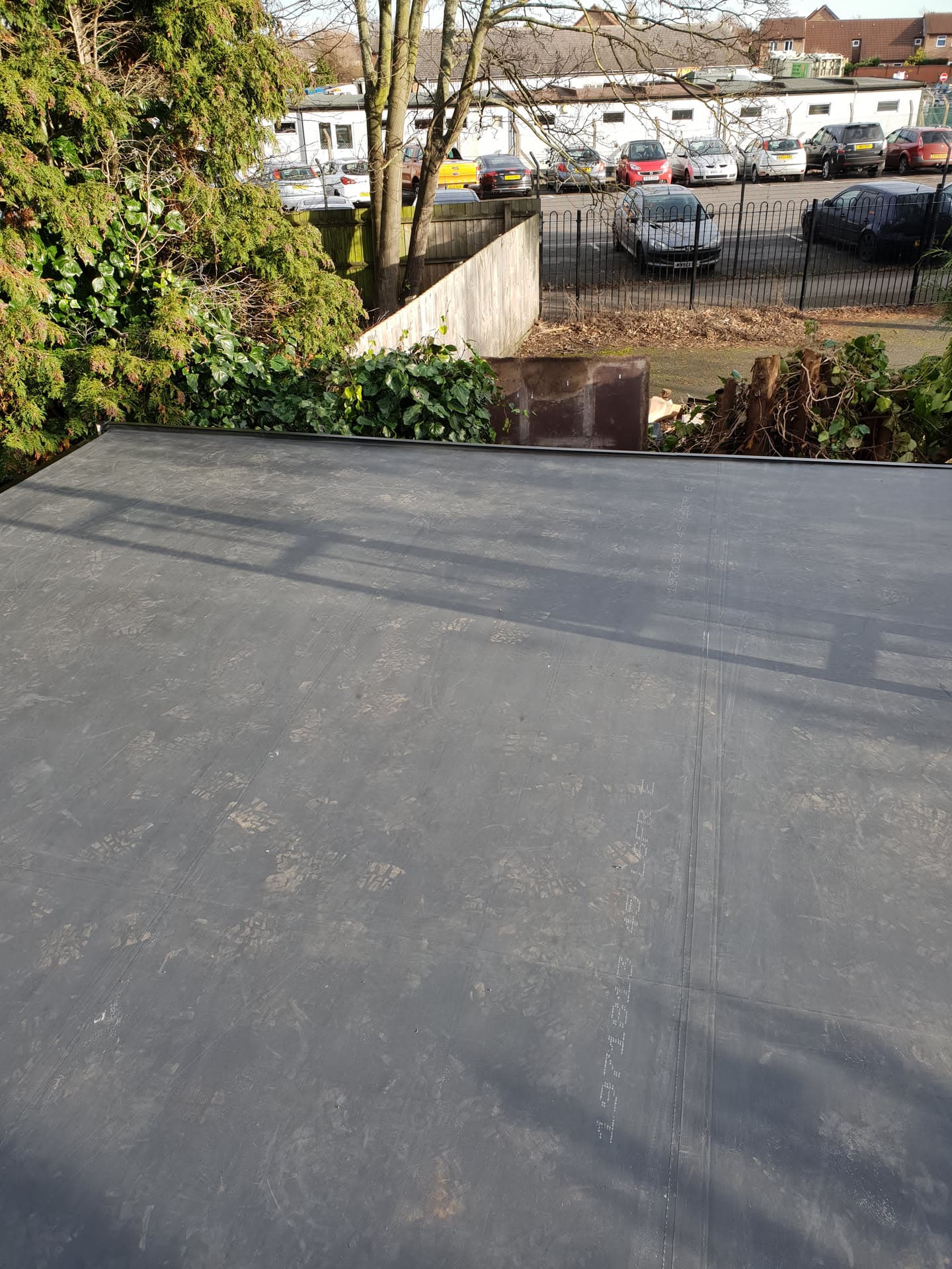 Completed grey EPDM rubber flat roof installation on residential extension