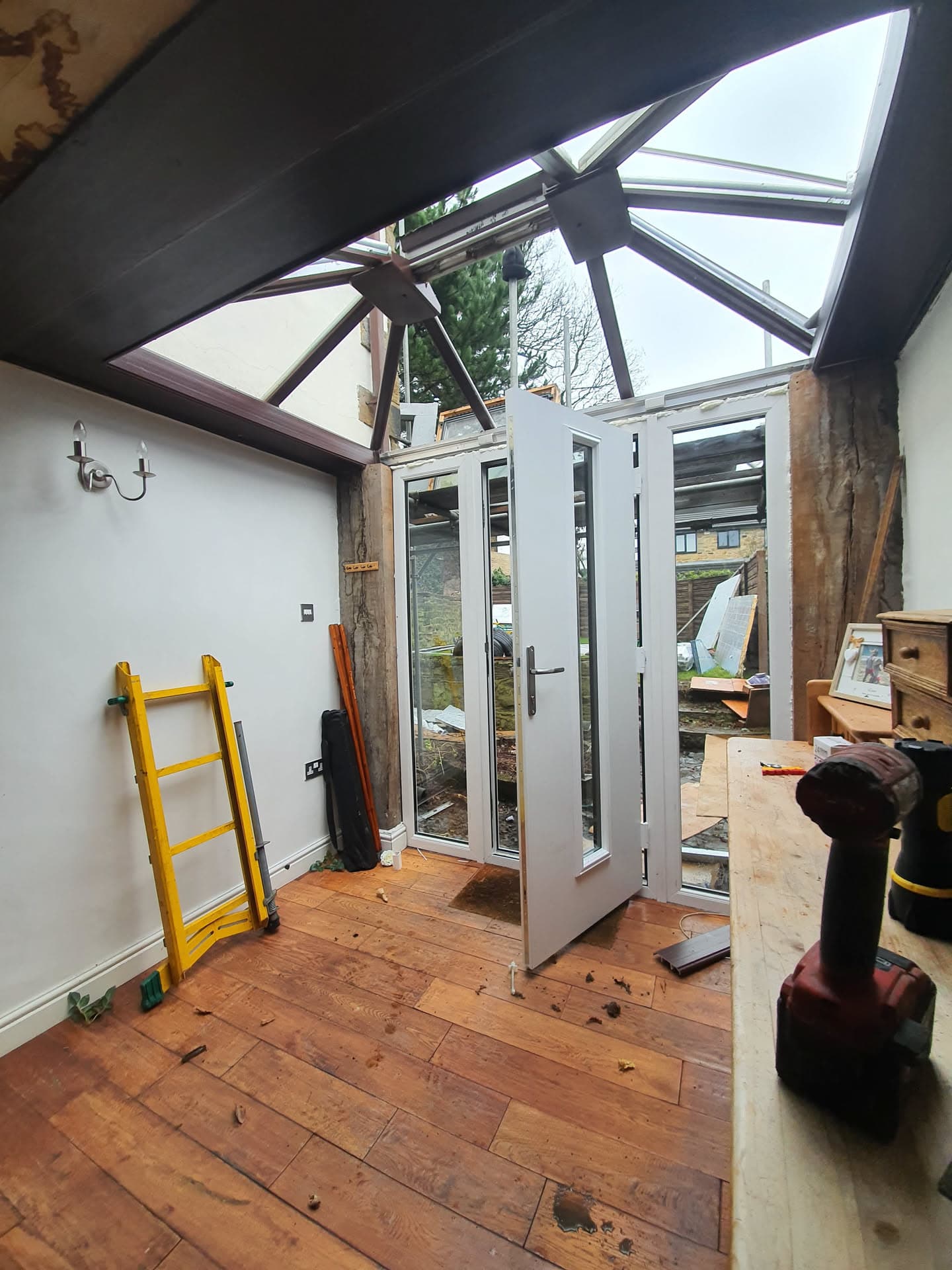 Conservatory roof with anthracite framework and glazed panels under construction