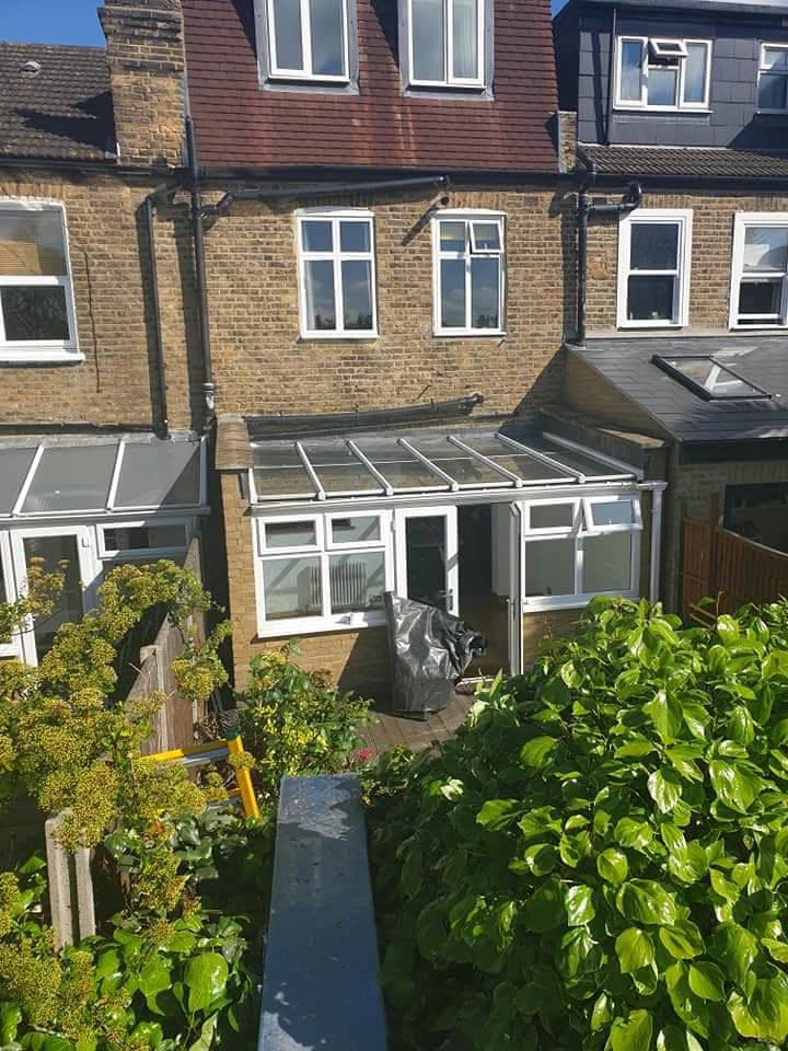 Conservatory with grey polycarbonate roof panels on terraced house