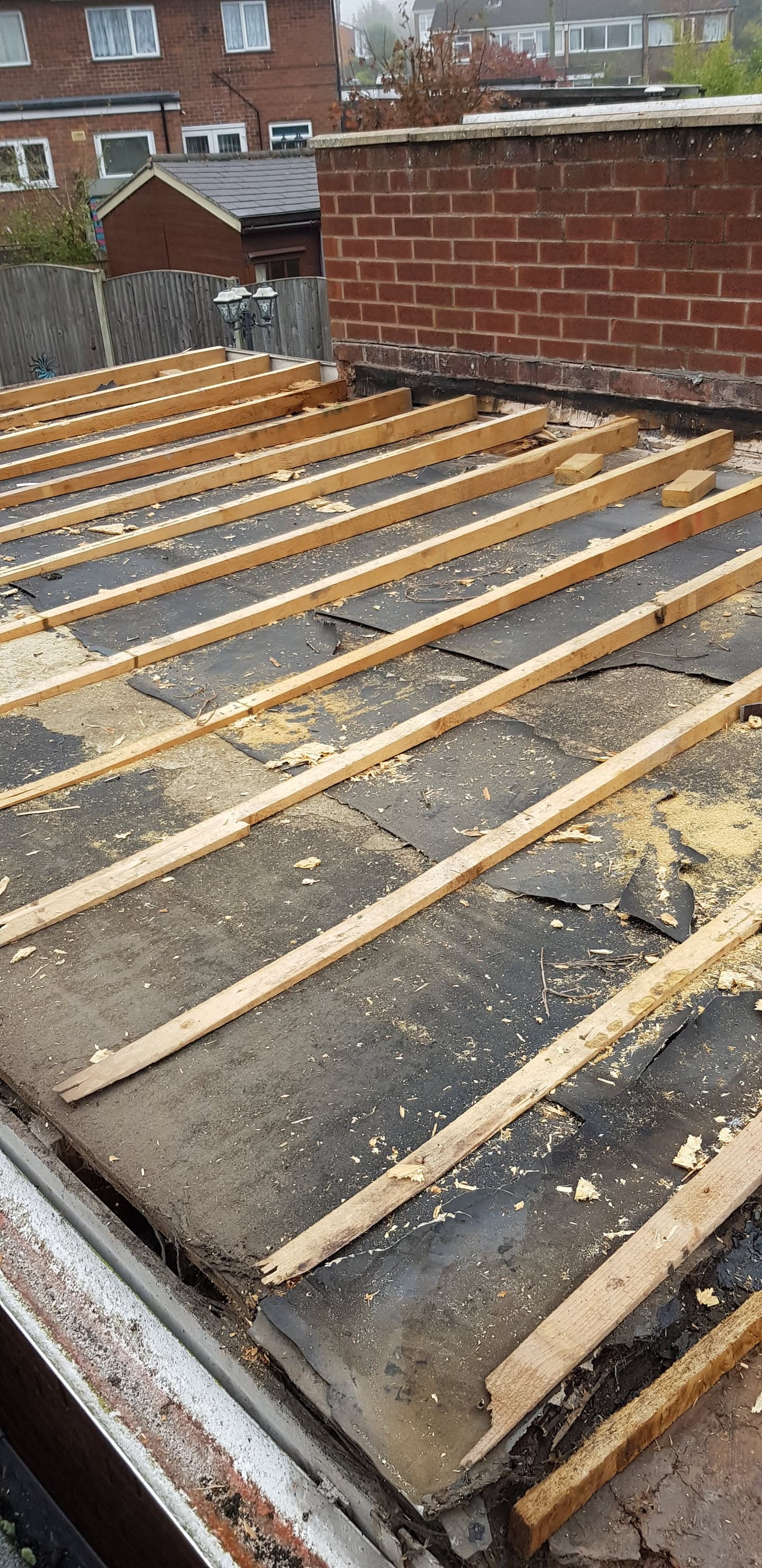 Timber battens installed on flat roof surface ready for new roofing material