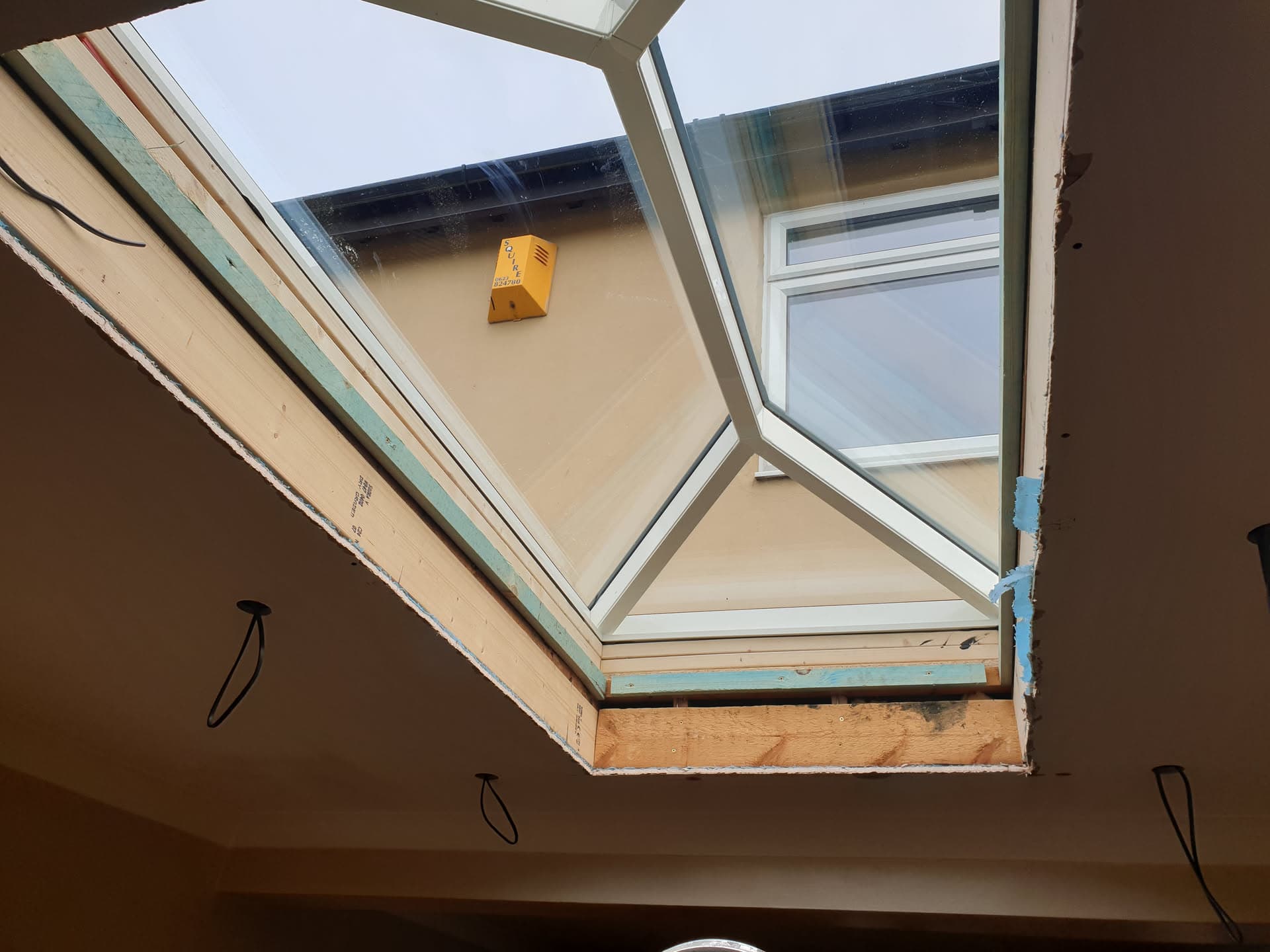 Roof window installation in progress showing timber frame and insulation boards