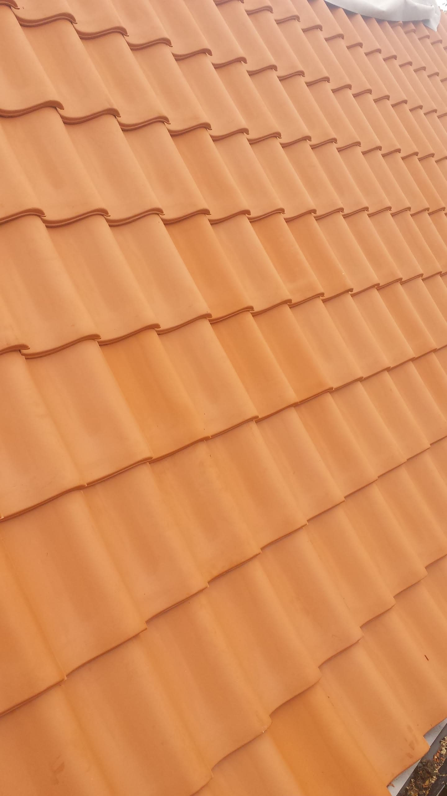 Pitched roof with terracotta interlocking concrete tiles
