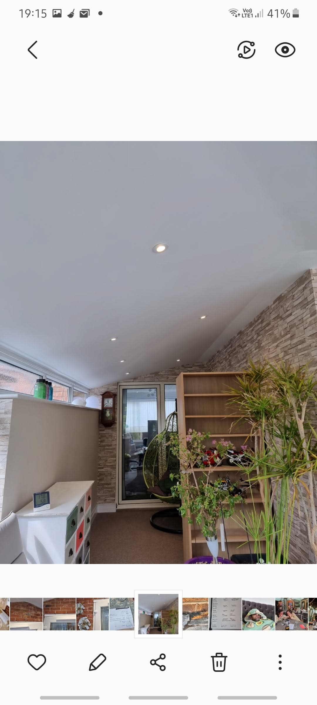 Interior view of converted space with white ceiling, recessed lighting and exposed brick wall