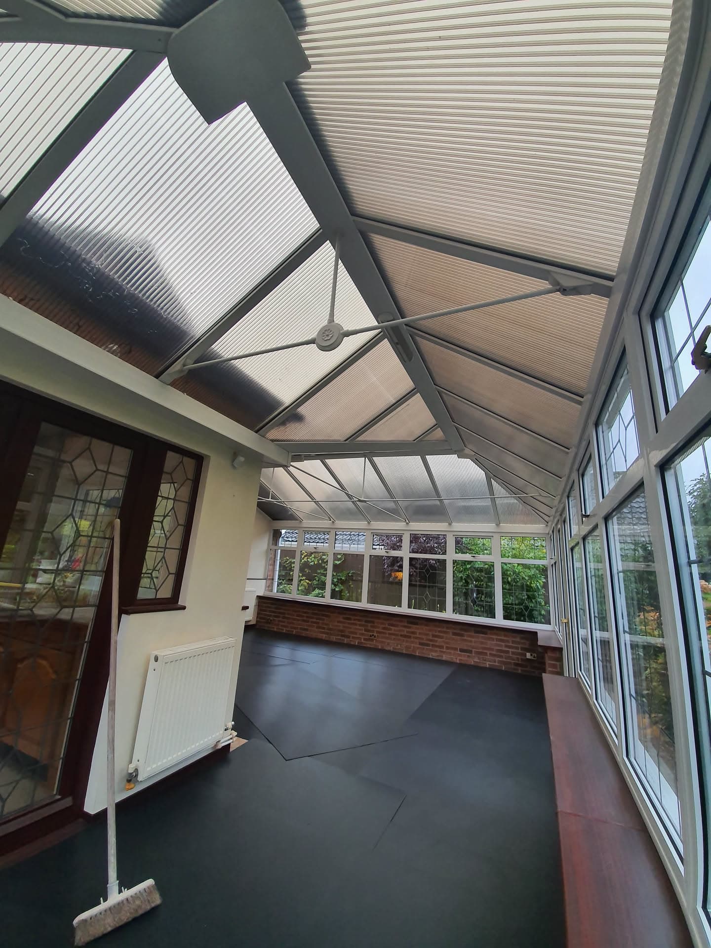 Conservatory roof with anthracite frame and polycarbonate panels viewed from inside