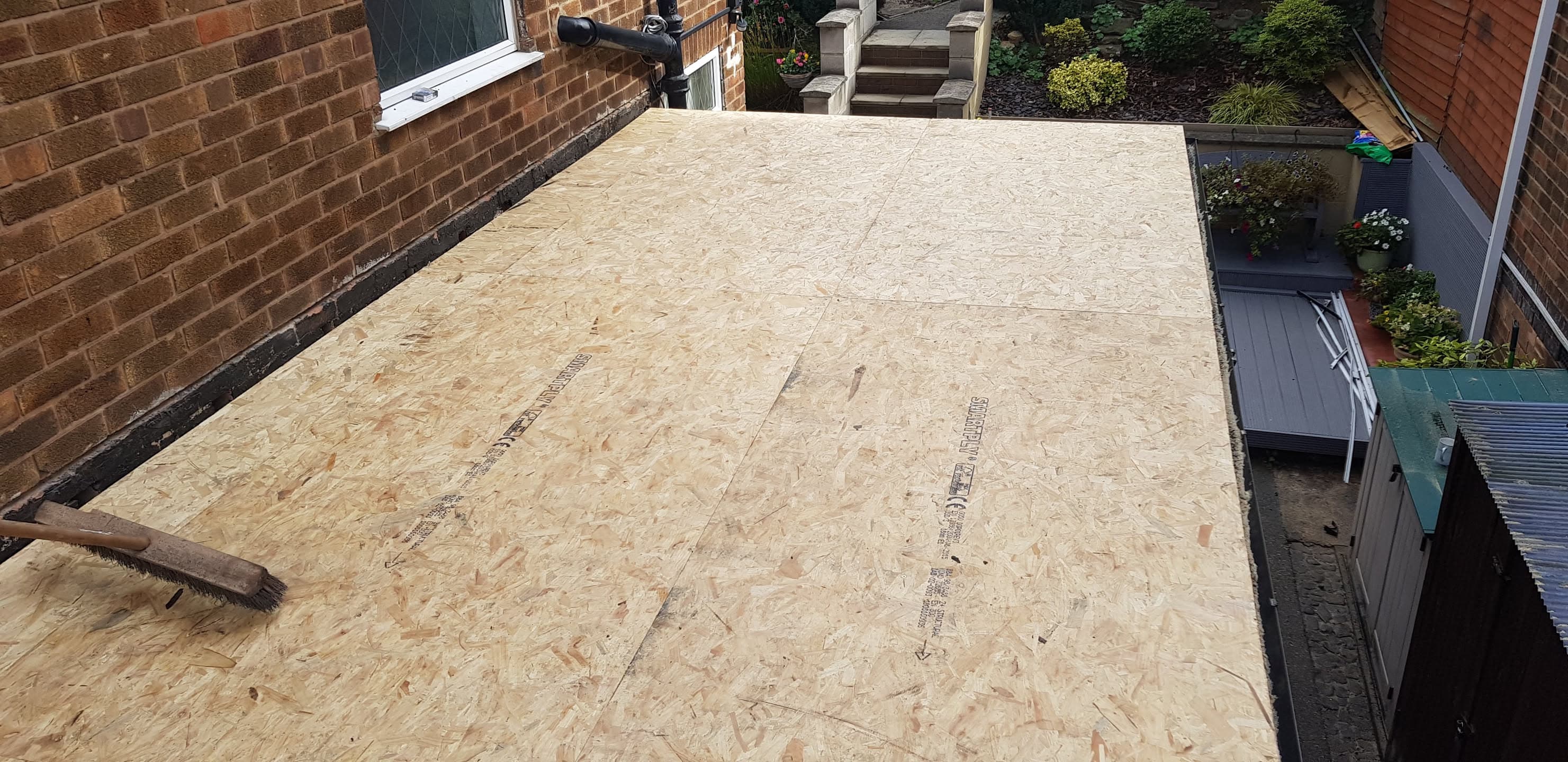 Flat roof with new OSB decking boards installed ready for weatherproofing