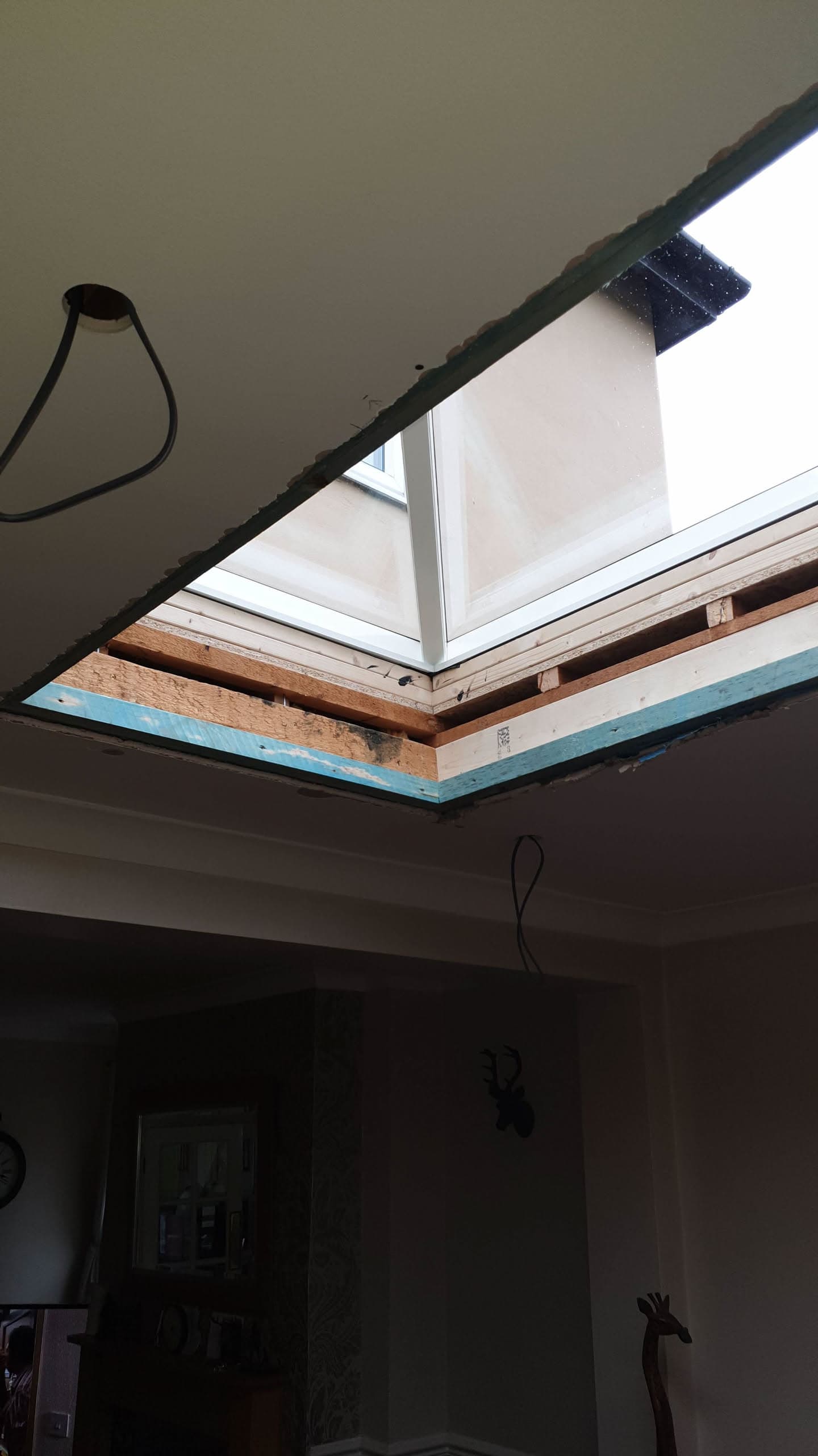 Interior view of skylight installation with exposed timber frame and insulation