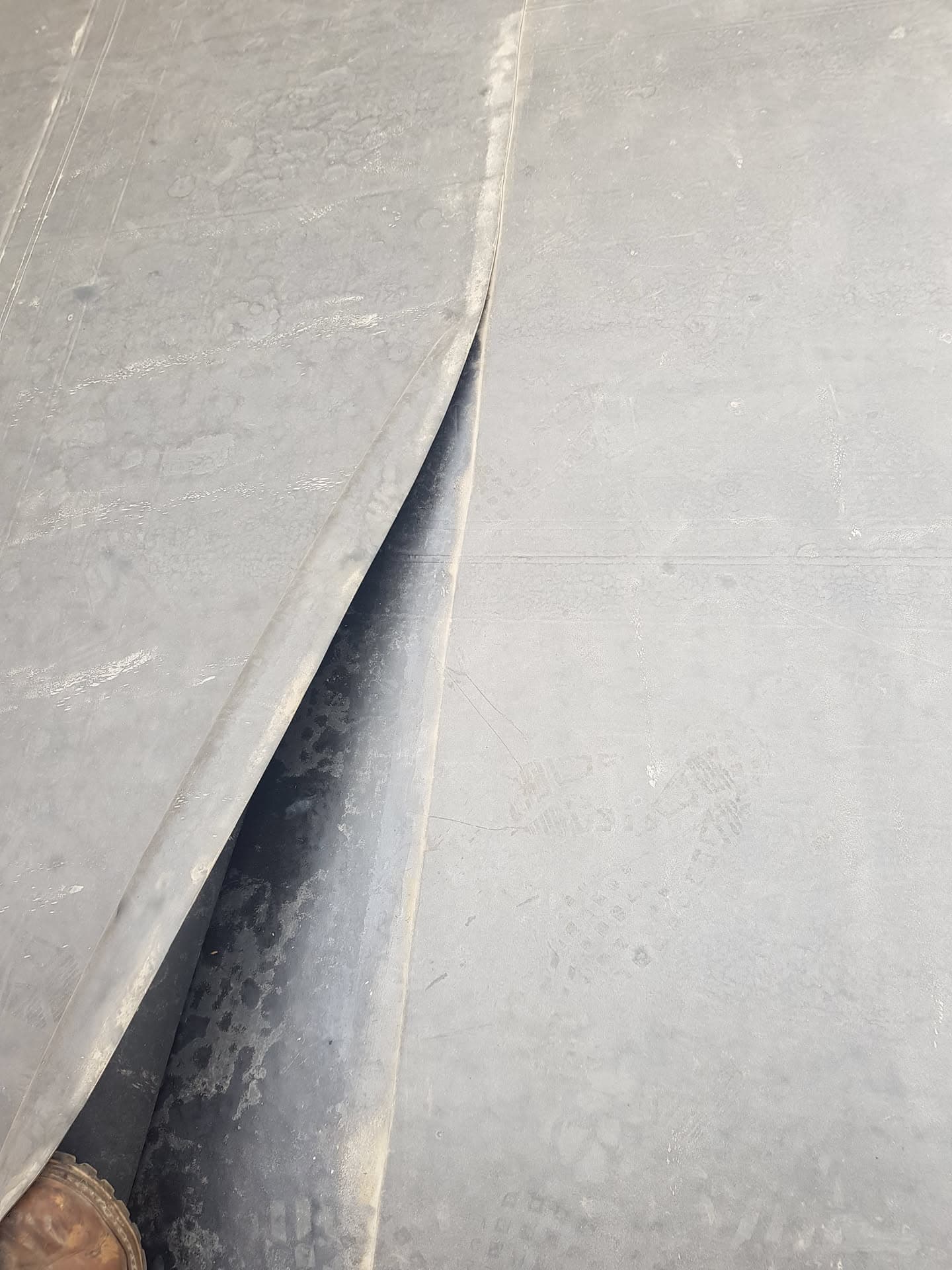 Grey GRP fibreglass flat roof with visible valley gutter detail