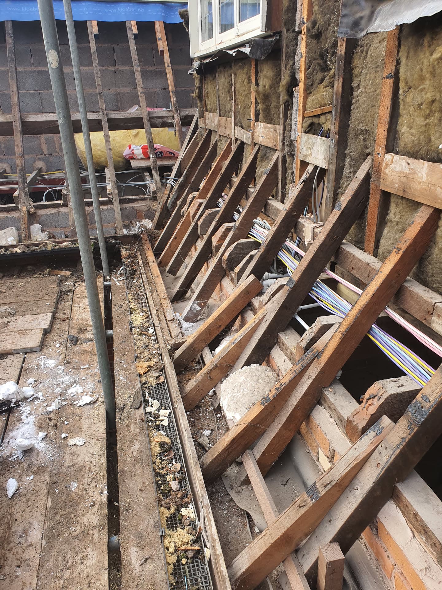 Exposed roof structure during renovation showing timber rafters, joists and insulation