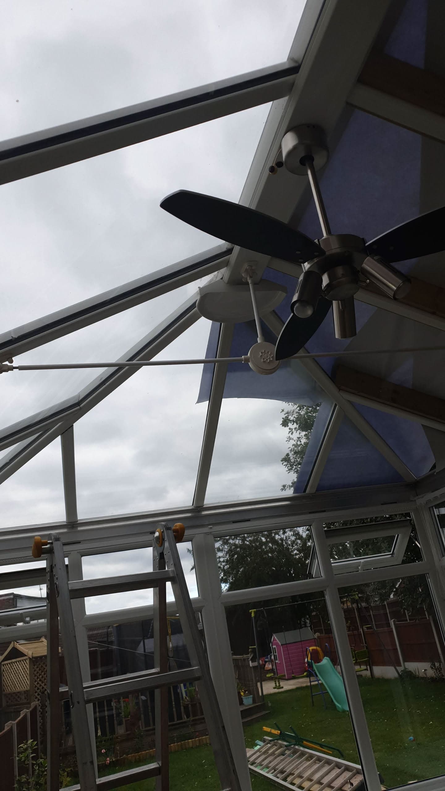 Interior view of conservatory roof with anthracite aluminium glazing bars and ceiling fan