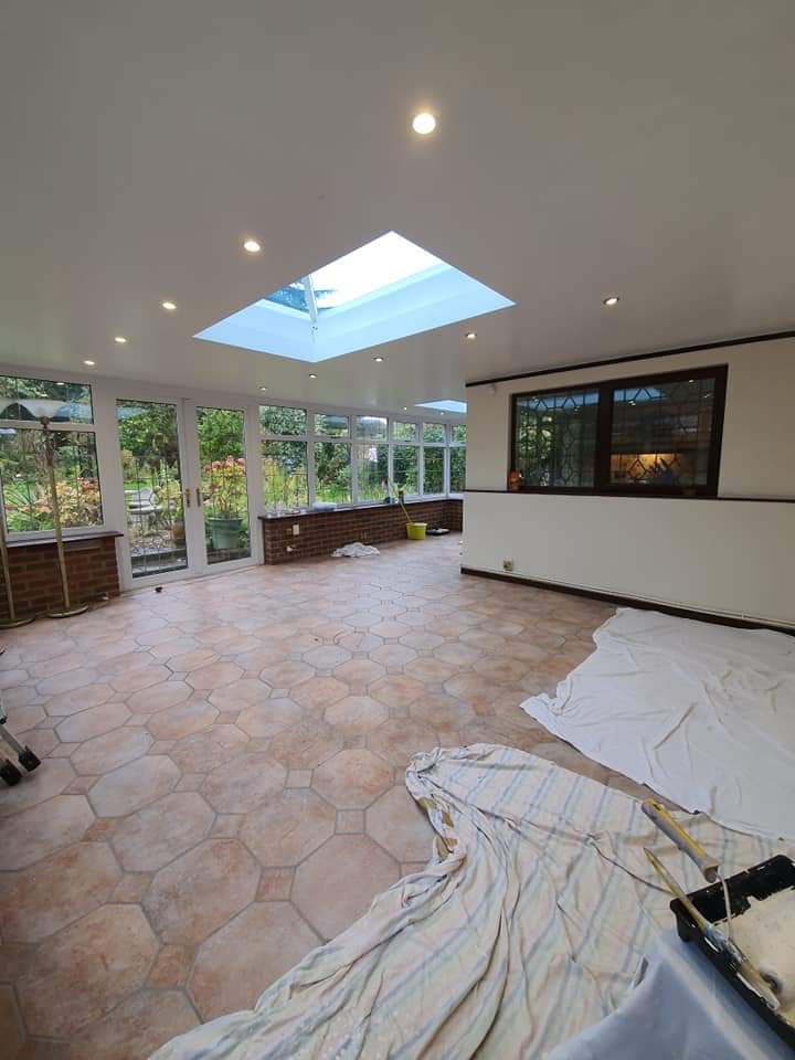 Interior view of conservatory extension with rectangular roof lantern skylight and white ceiling