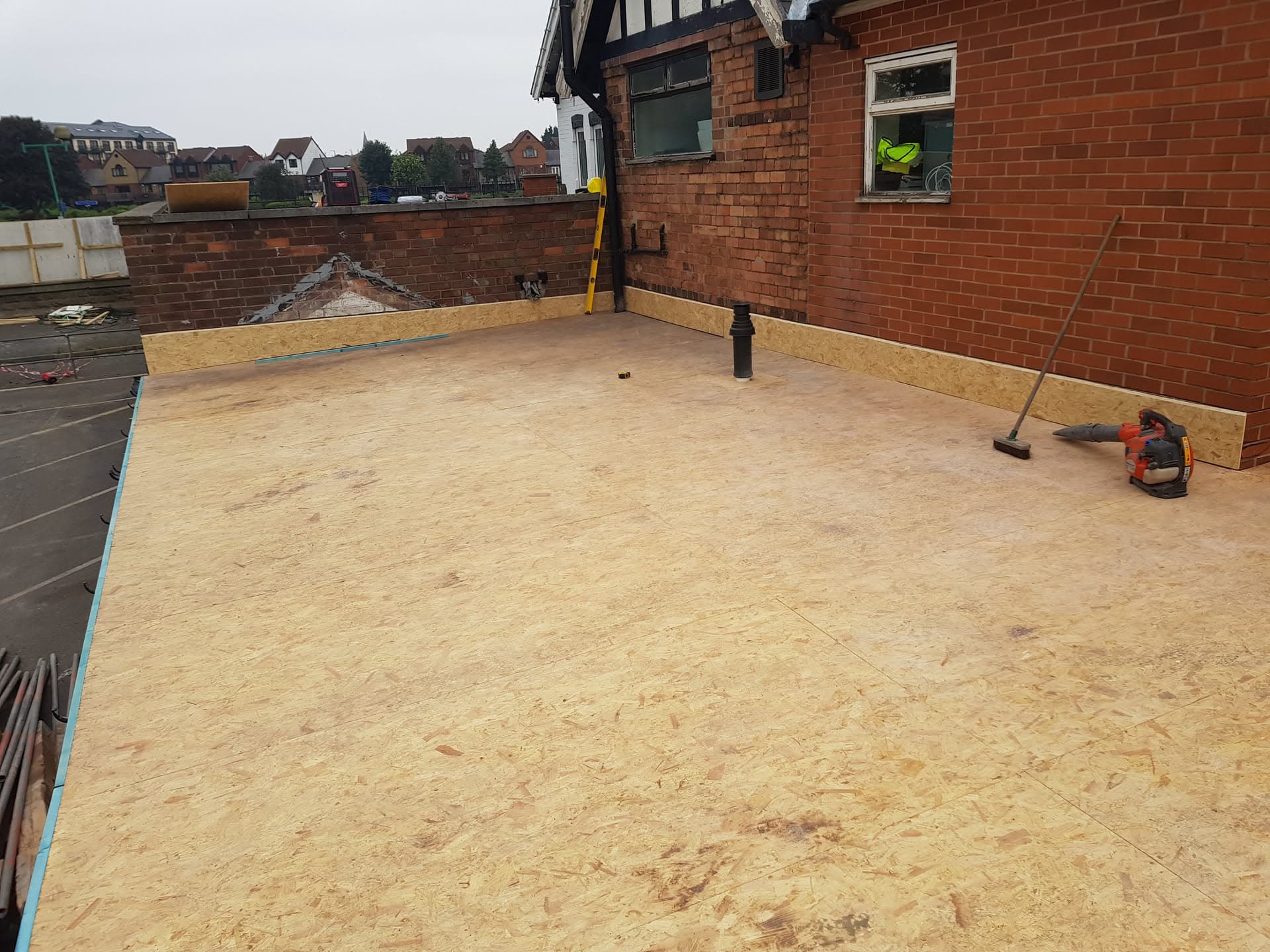 Flat roof with new OSB decking and timber upstands ready for waterproofing membrane