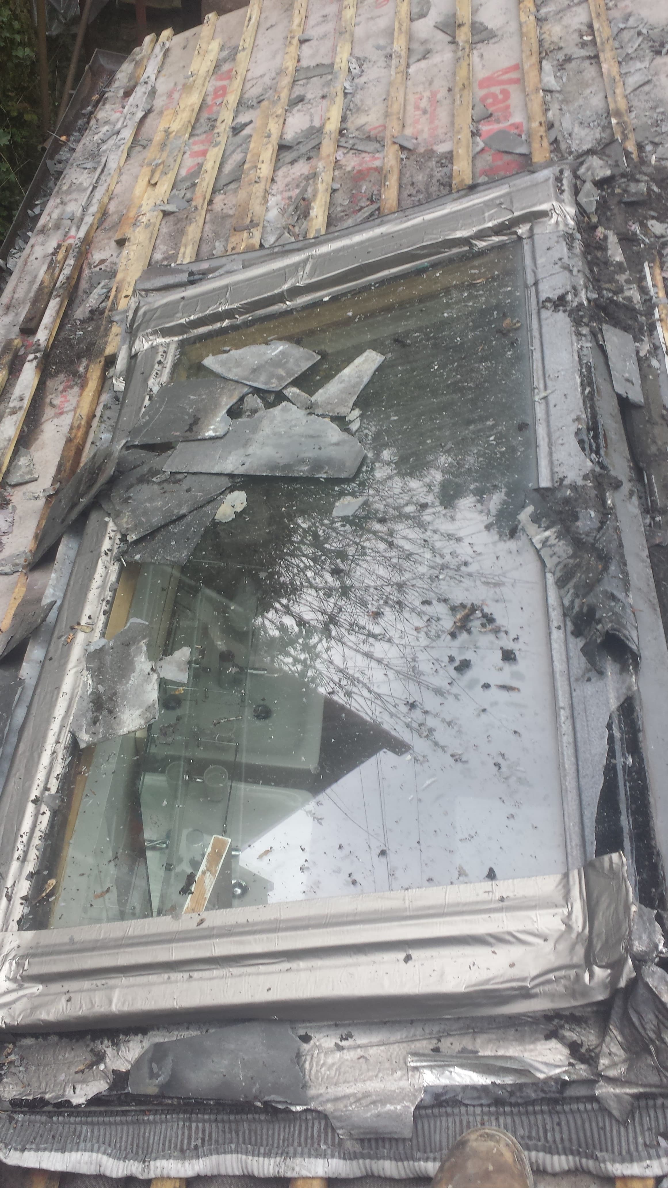 Conservatory roof during renovation with old glass panels removed and timber battens exposed