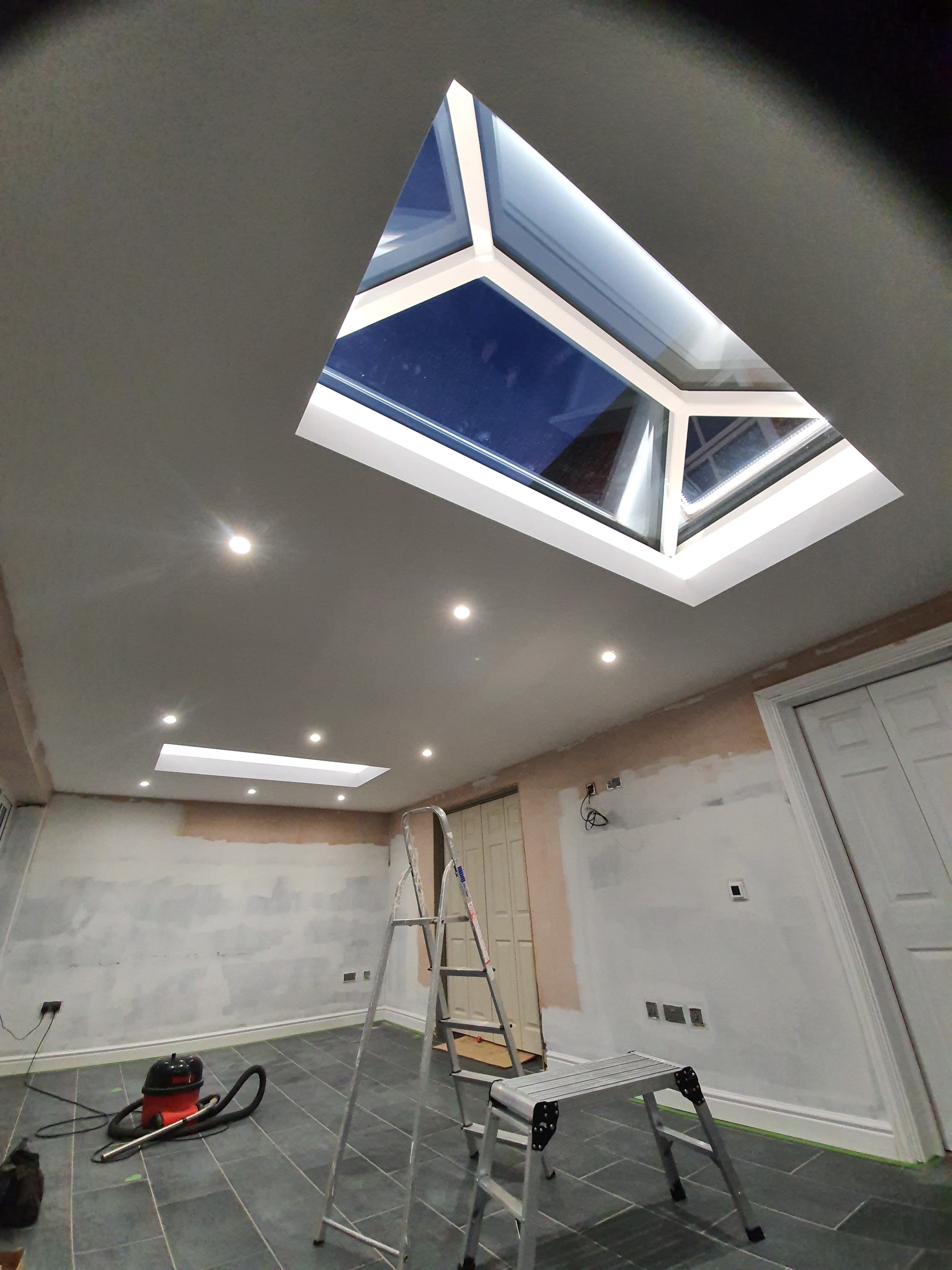 Lantern roof light with white uPVC frame and glazed panels installed in flat ceiling