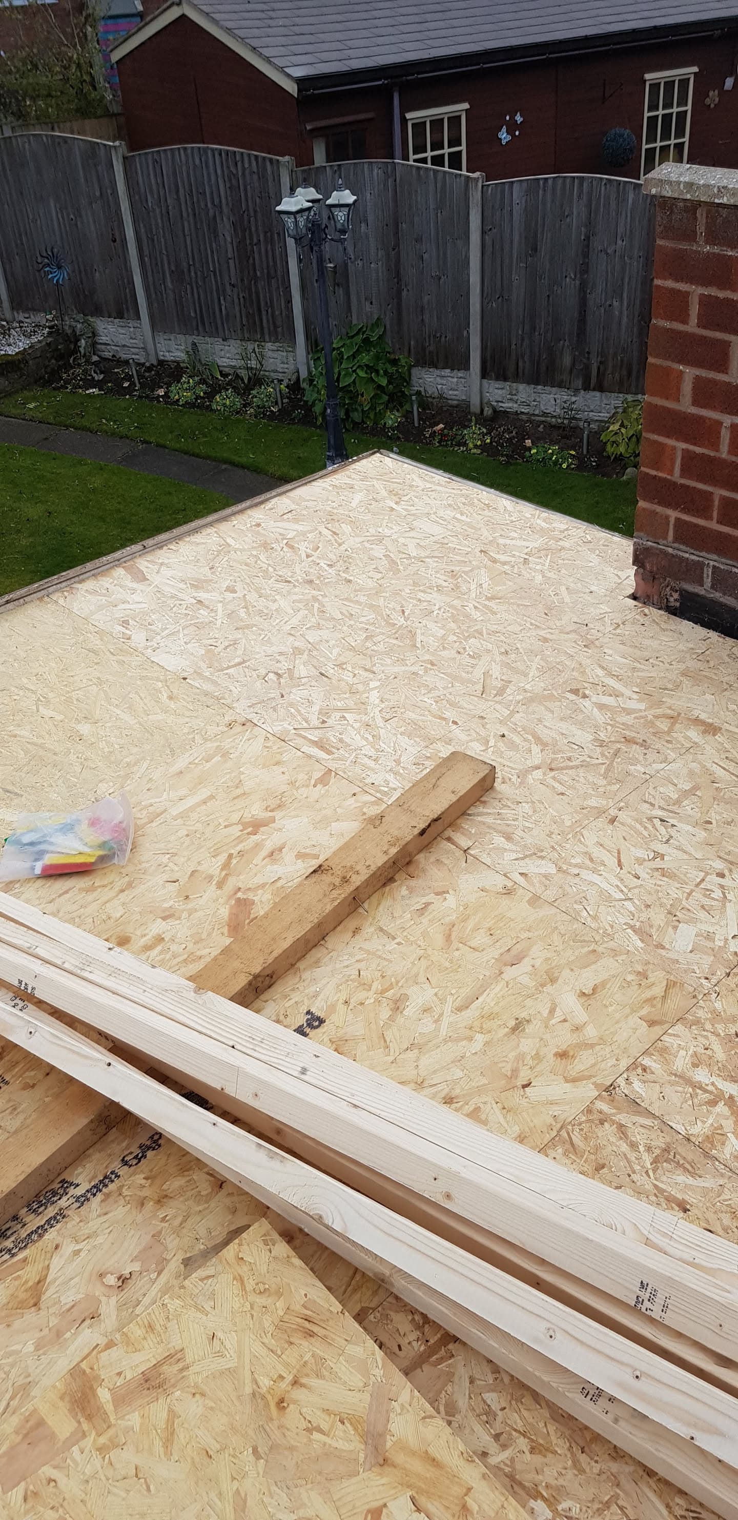 Flat roof construction with OSB decking boards and timber joists in progress