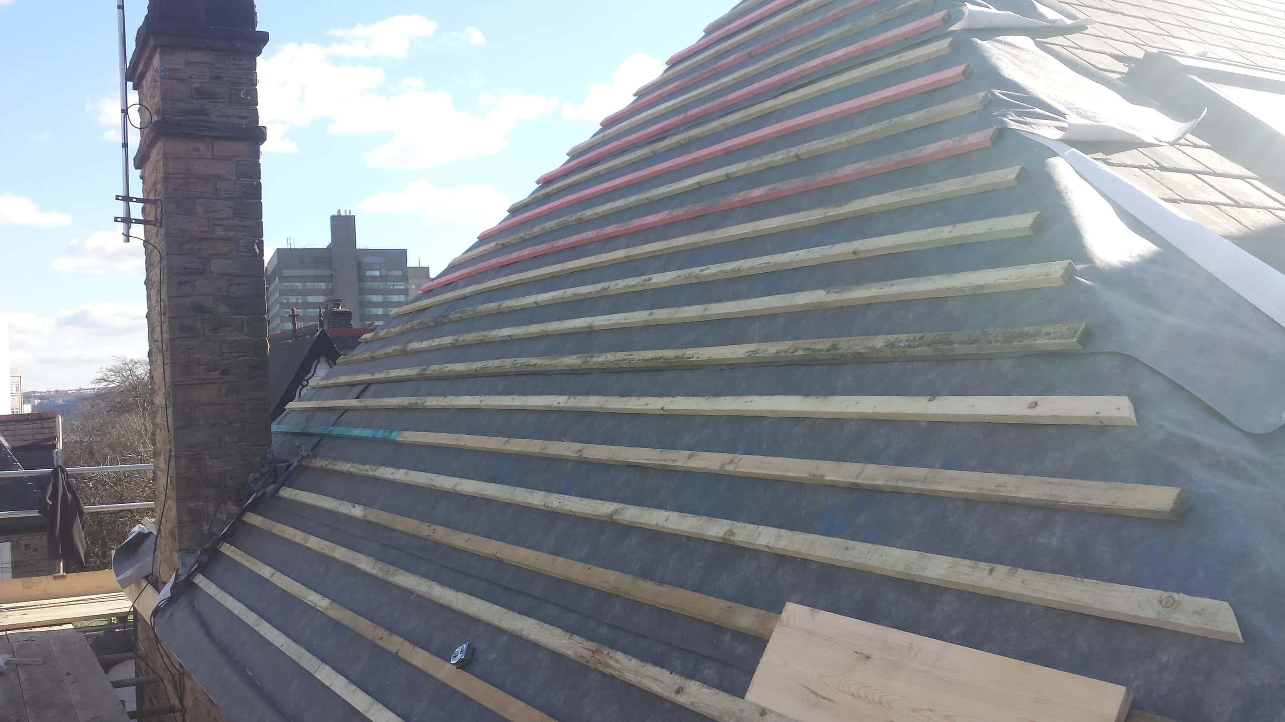 Pitched roof covered in breathable membrane with new timber battens fitted, ready for tiling