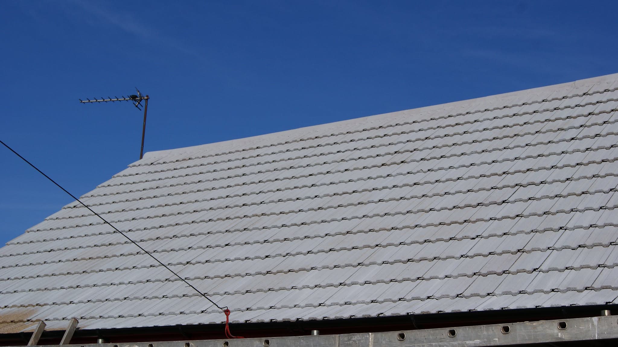 Pitched roof with grey concrete tiles and visible fascia board