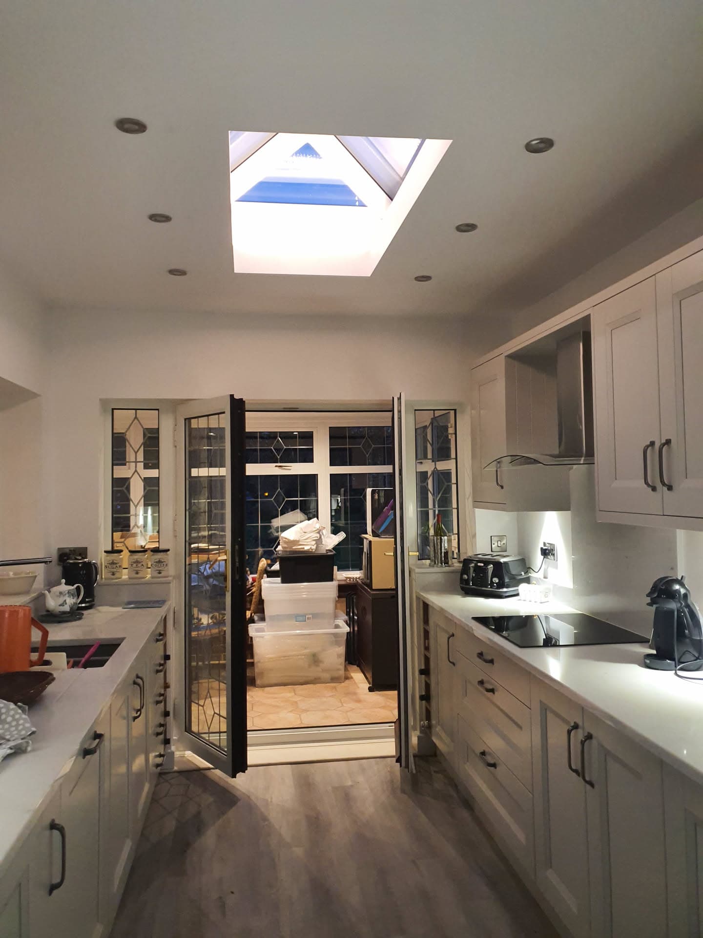 Kitchen interior with white roof lantern skylight and recessed spotlights