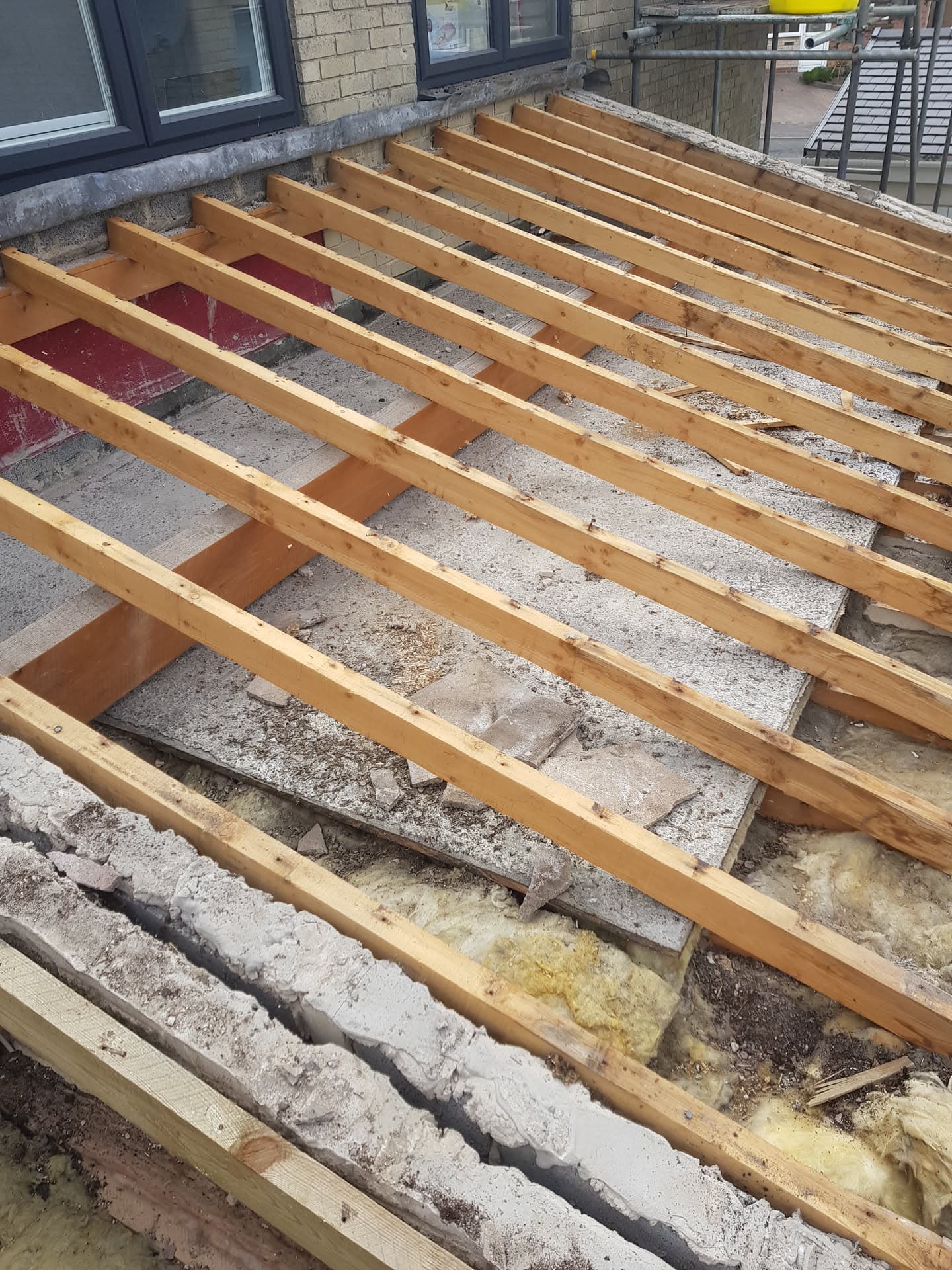 New timber joists installed on flat roof during replacement work