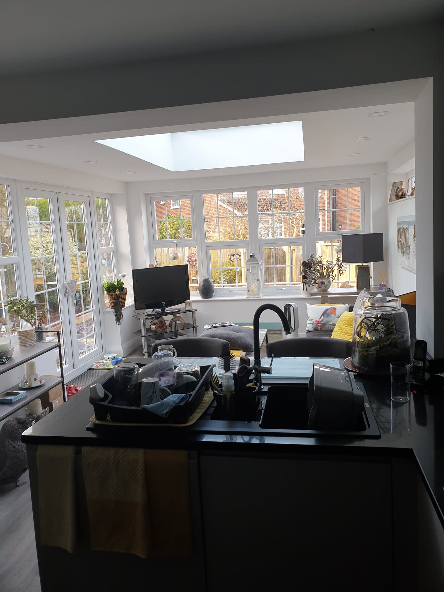 Interior view of conservatory extension with white uPVC frames and flat roof lantern skylight