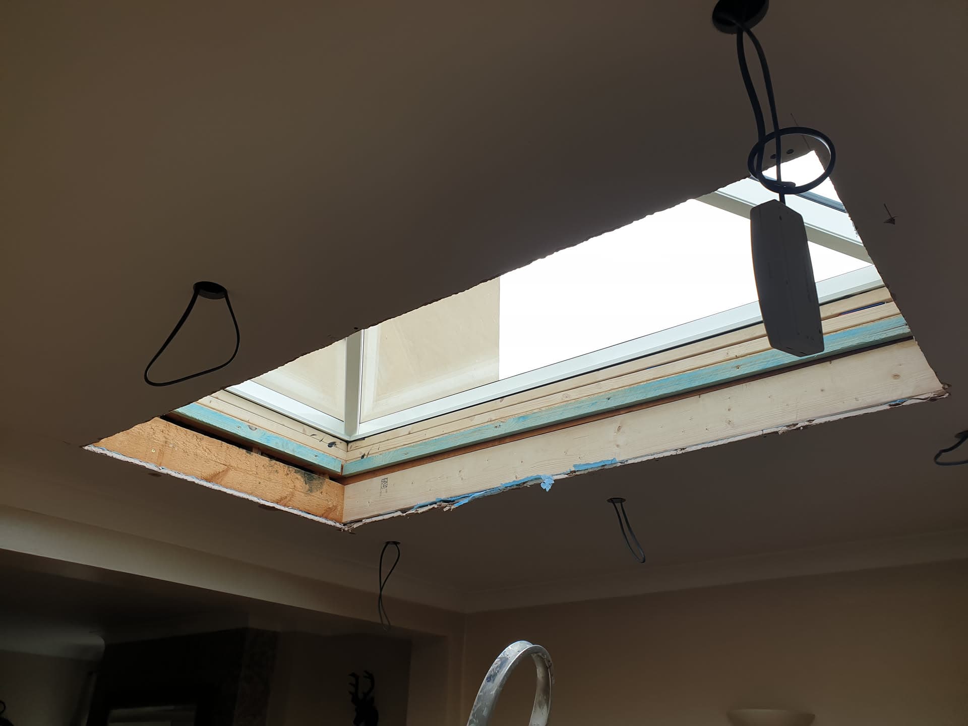 Flat roof skylight installation viewed from inside showing timber frame and glazing