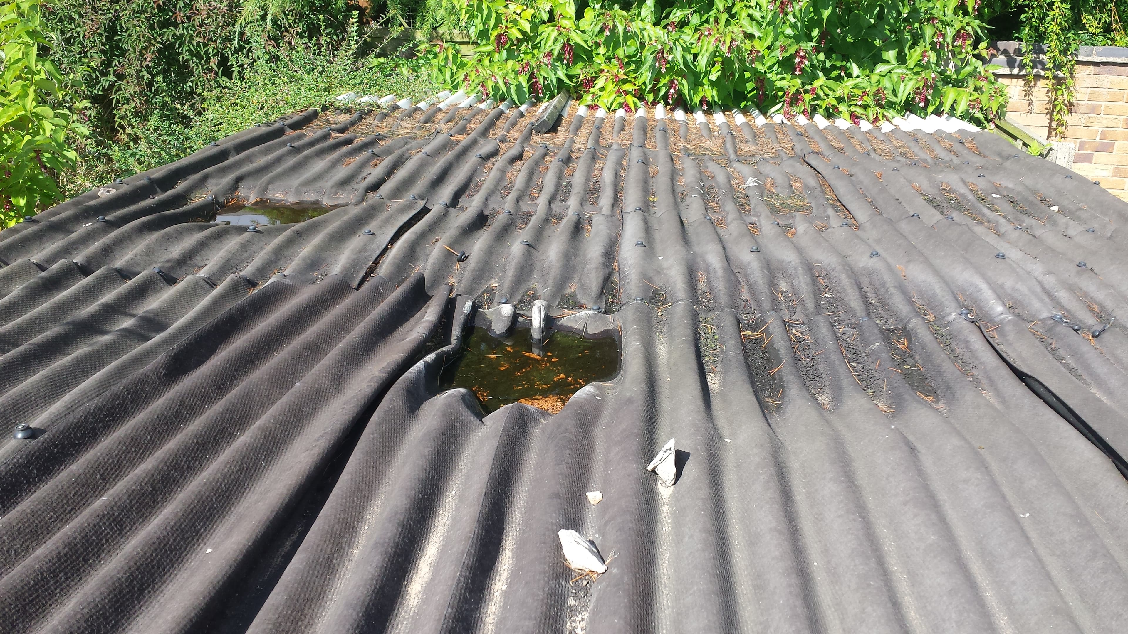Damaged corrugated metal roof with visible hole and weathering