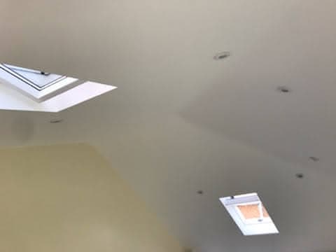 Interior view of white ceiling with two roof windows installed