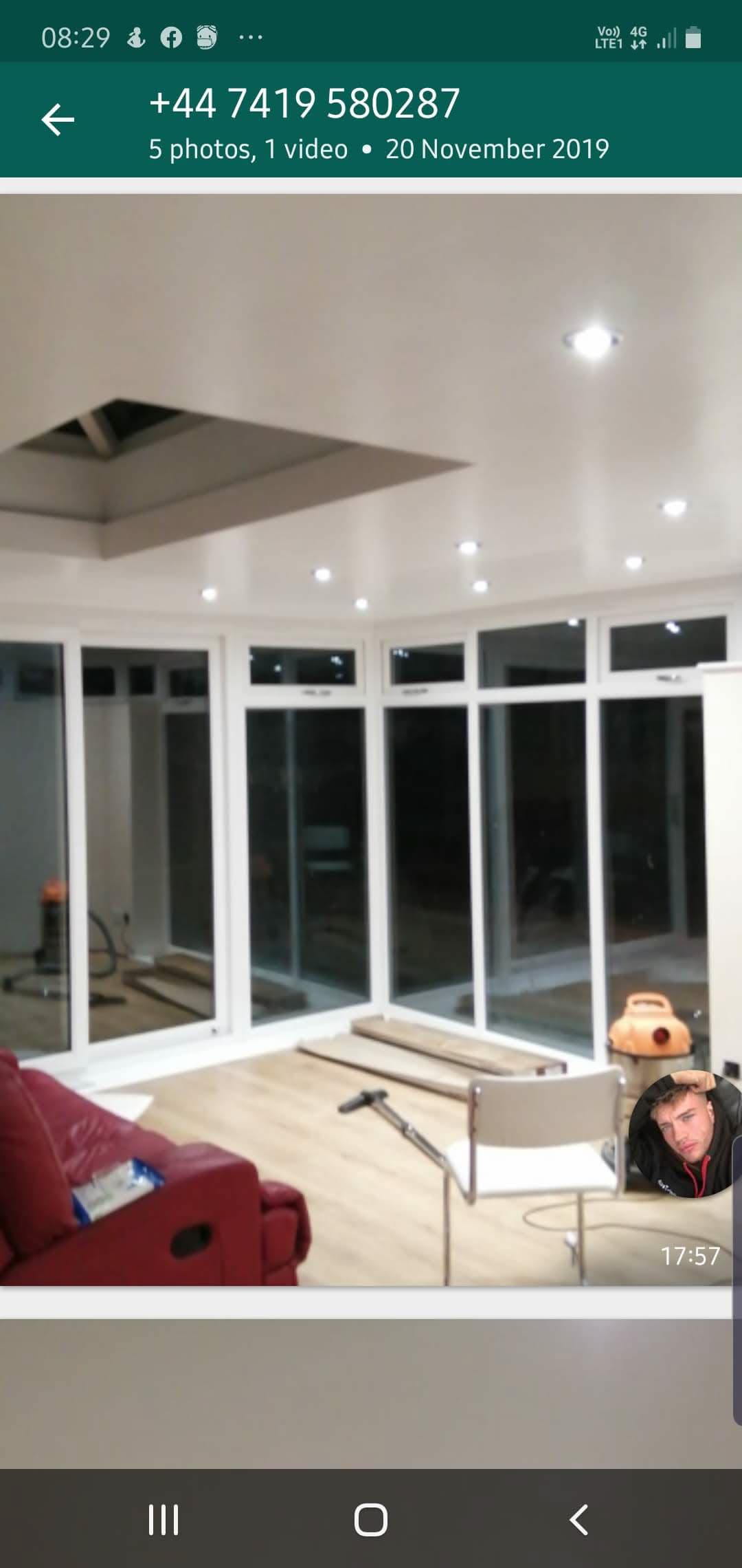 Interior view of completed conservatory with white uPVC frames and flat roof with recessed lighting