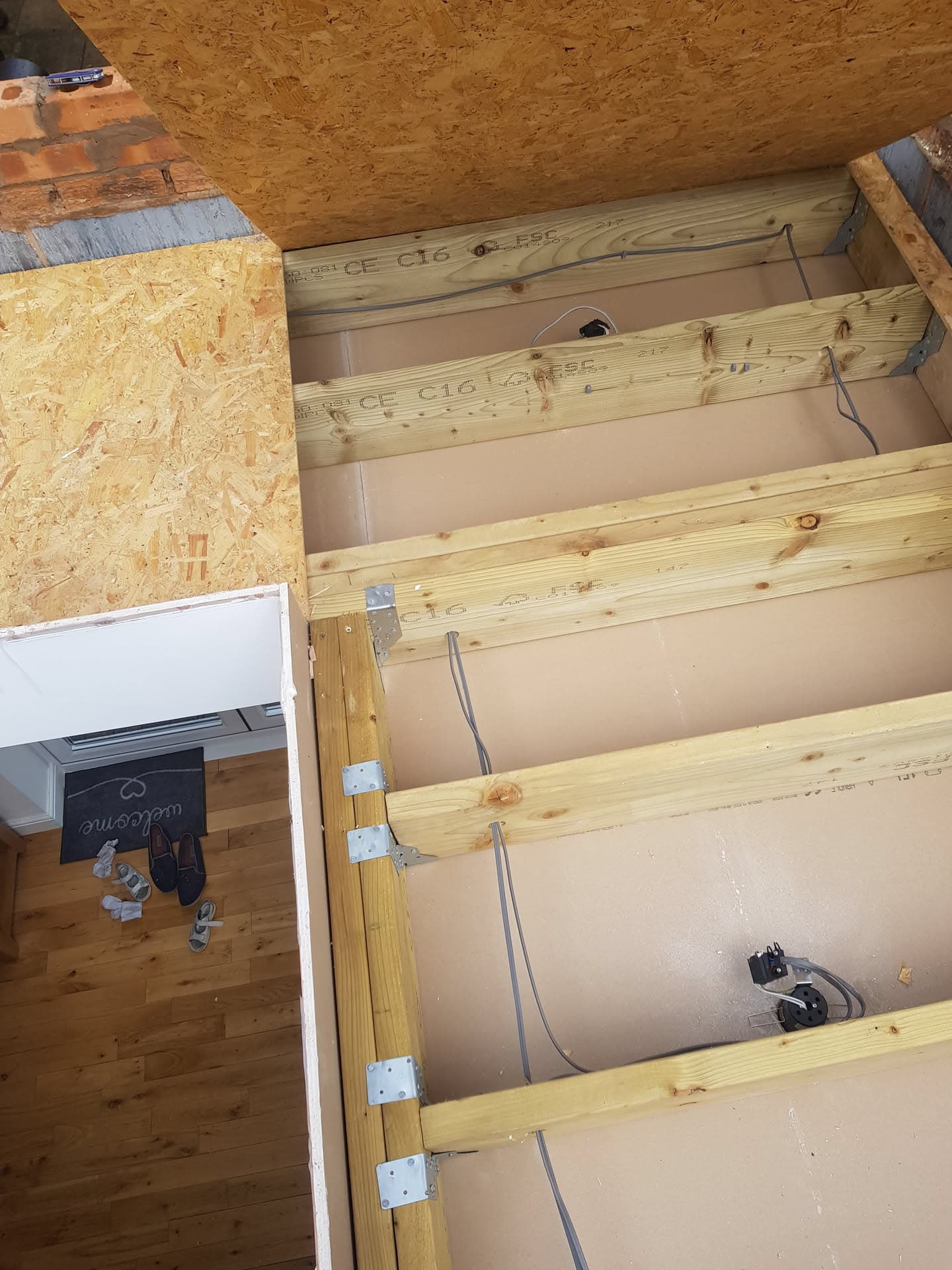 Flat roof construction with timber joists, insulation boards and OSB decking during installation