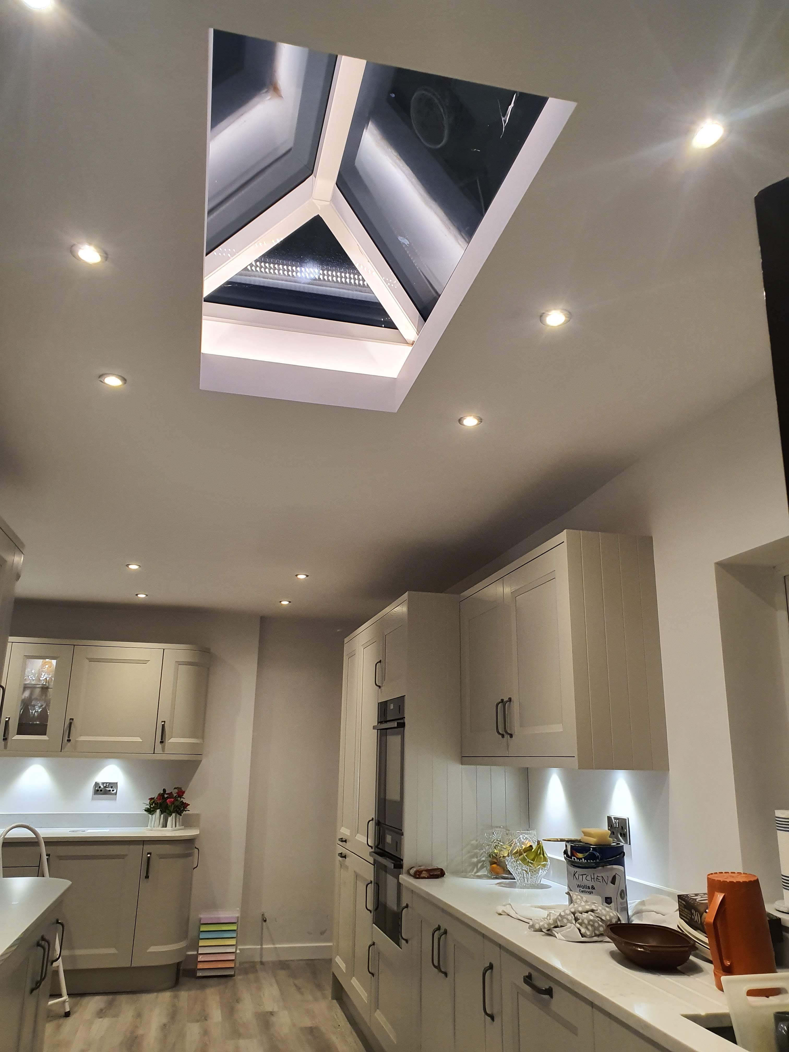 Interior view of kitchen with large roof lantern skylight and white frame
