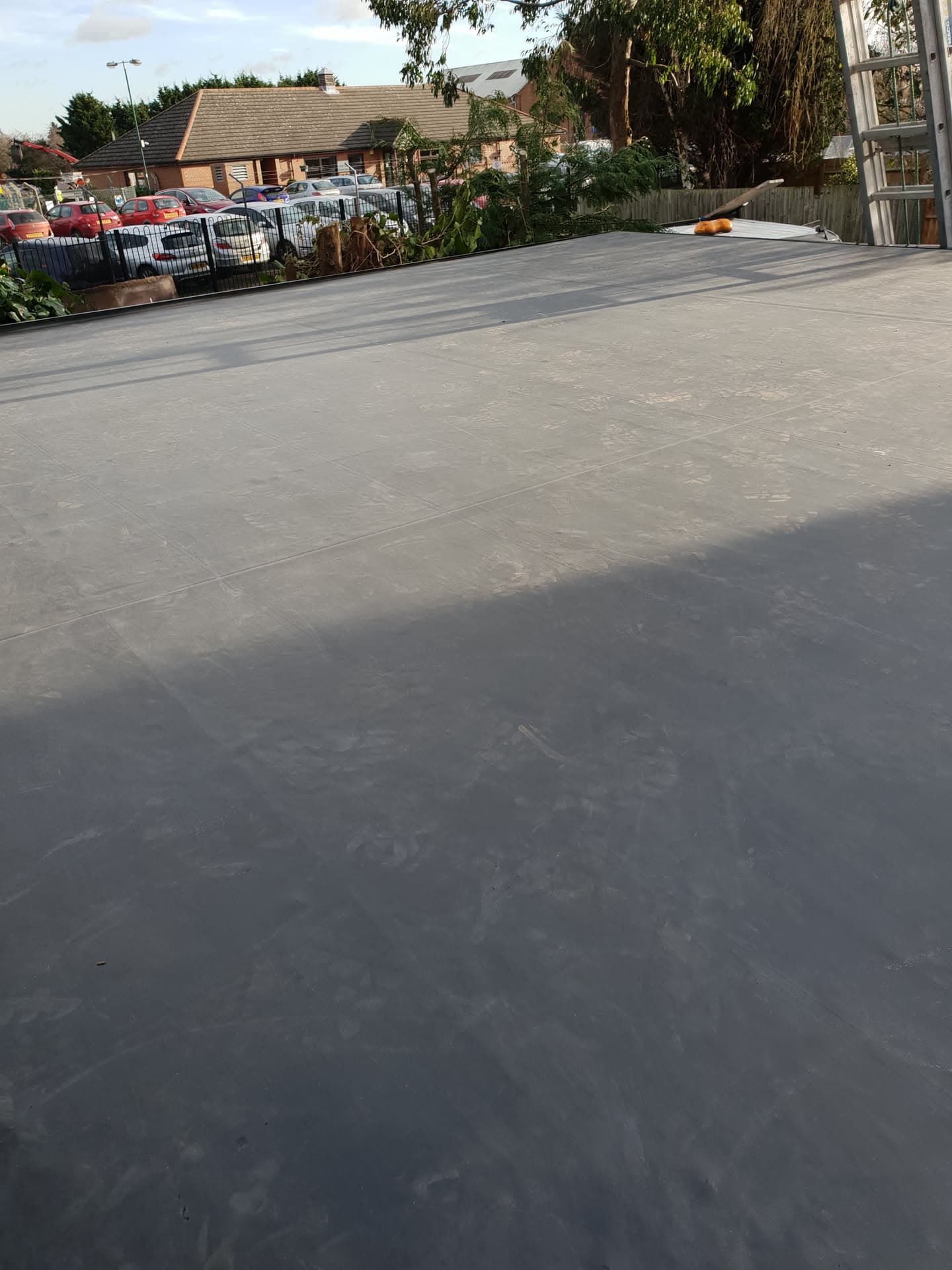 Completed grey EPDM rubber flat roof installation on residential extension