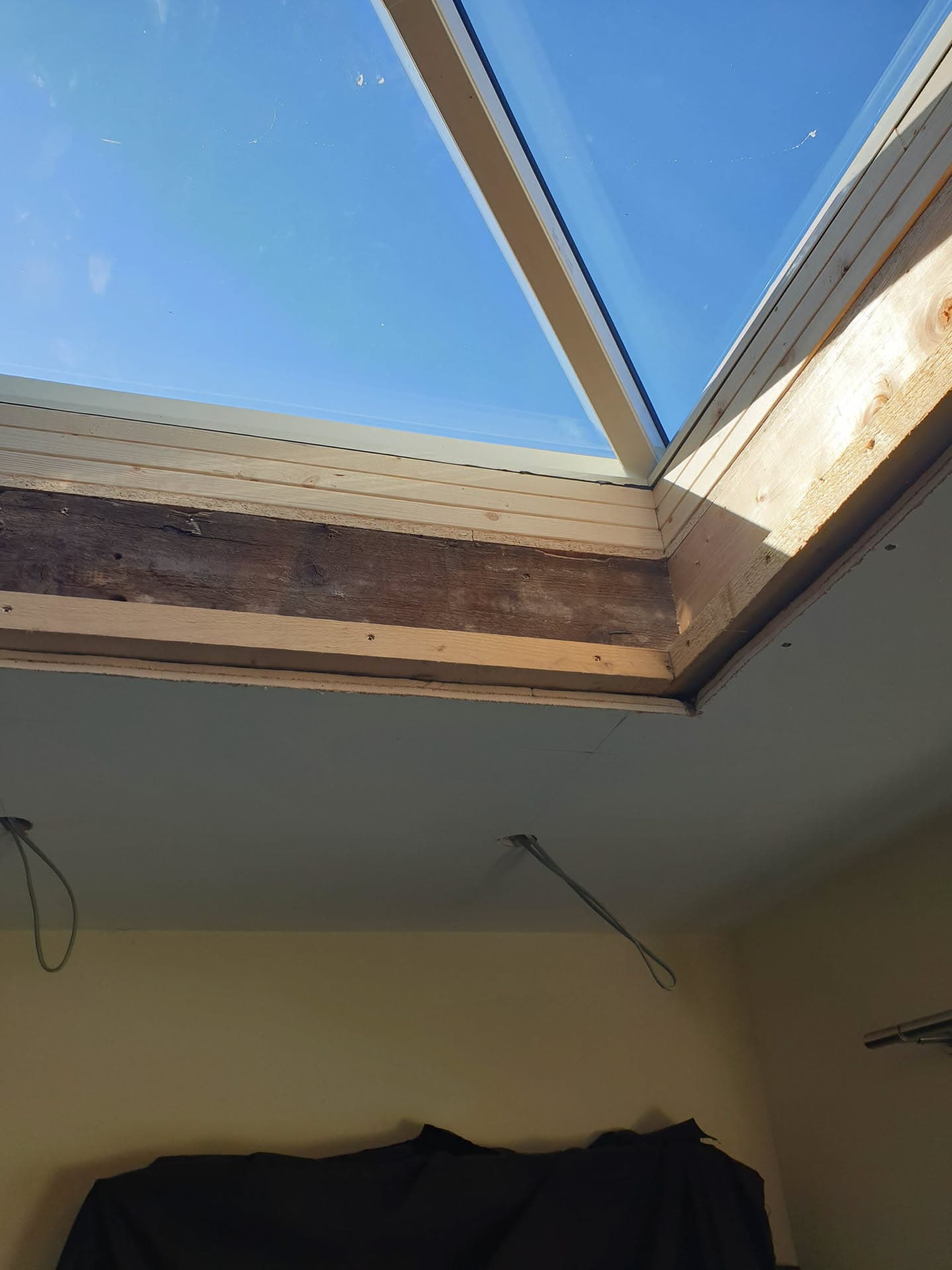 Glass roof light with timber frame and fascia boards viewed from inside