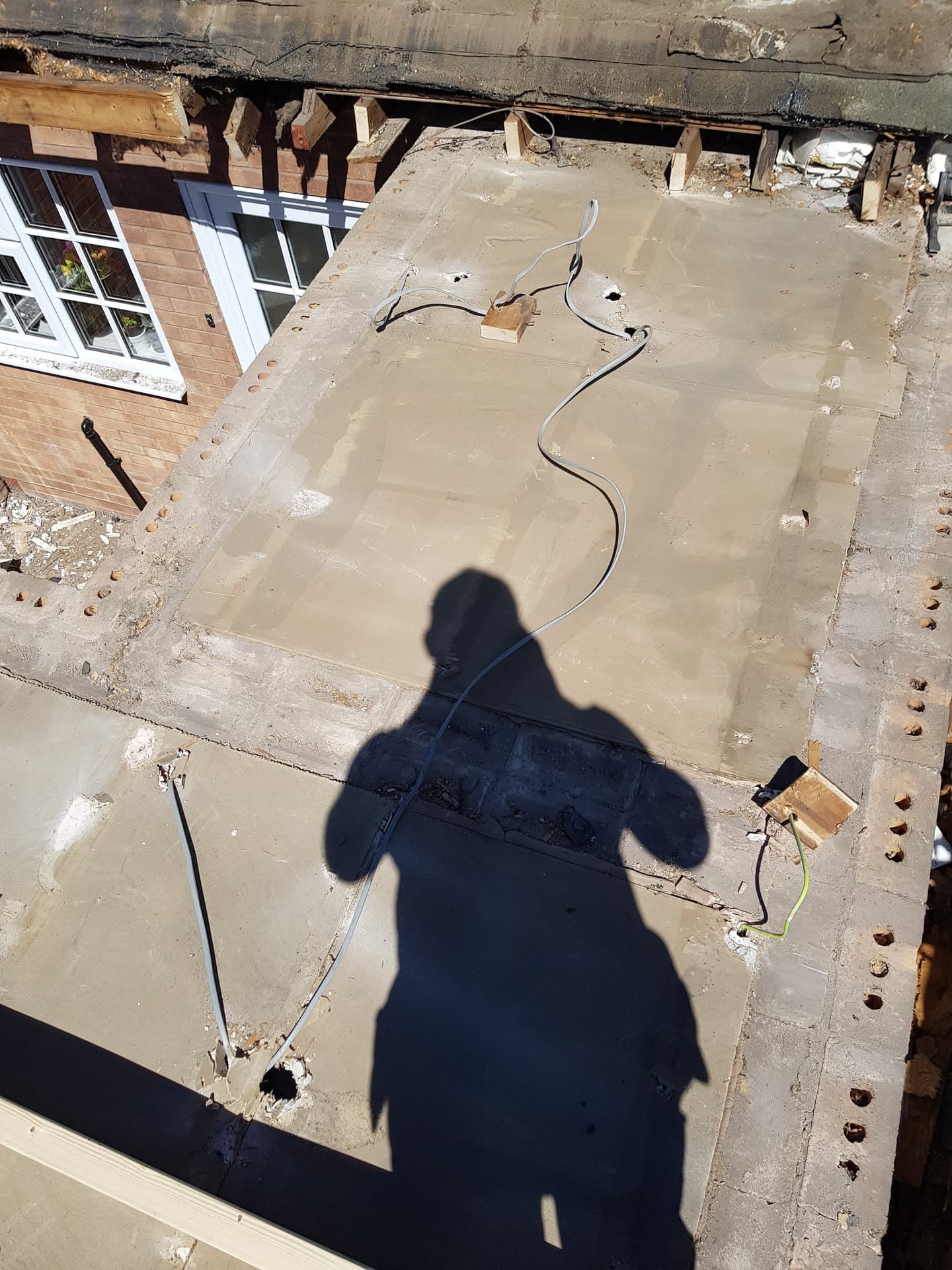 Flat roof with exposed timber joists and fascia boards during renovation work
