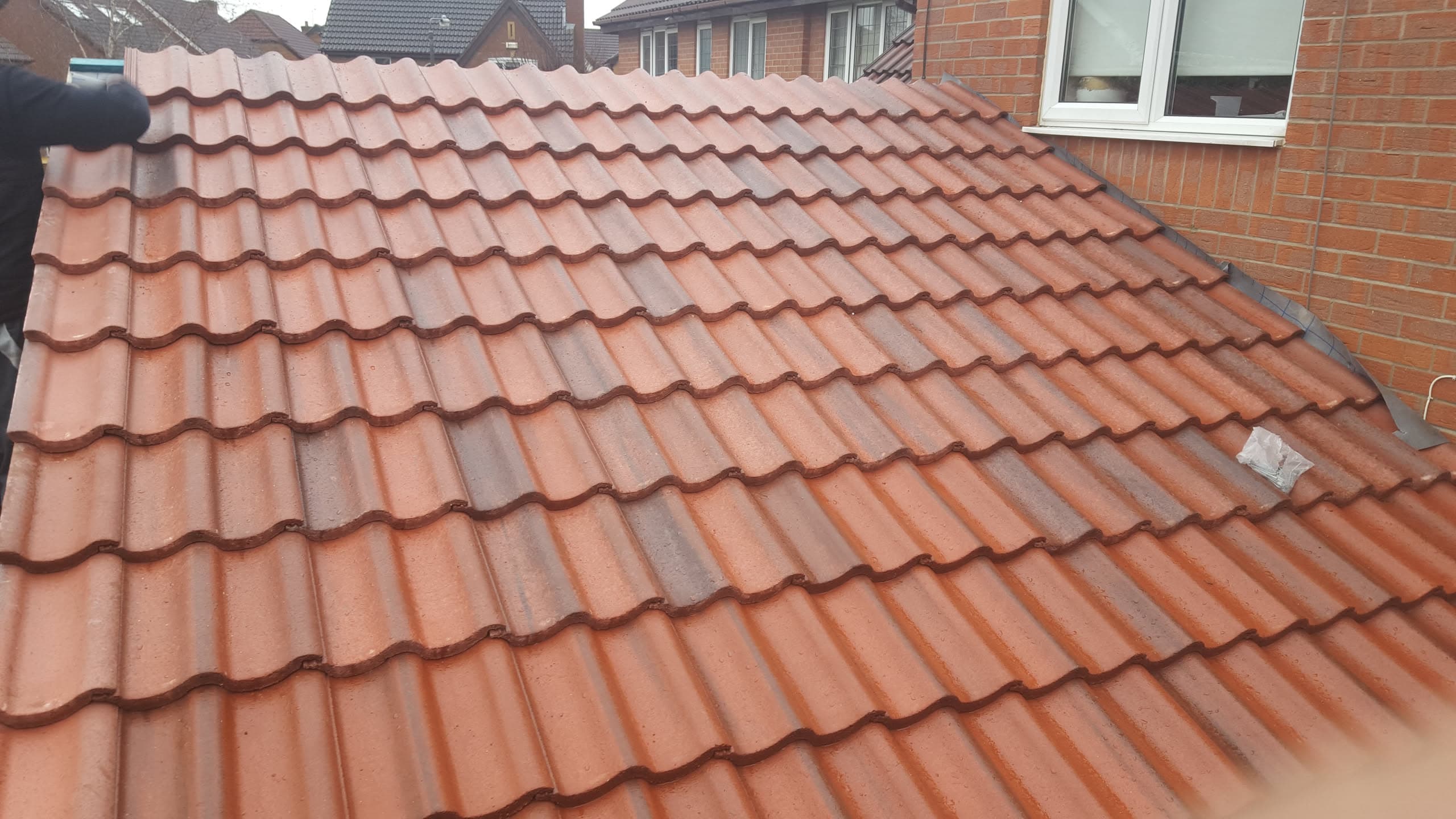 Pitched roof with terracotta concrete tiles on residential property