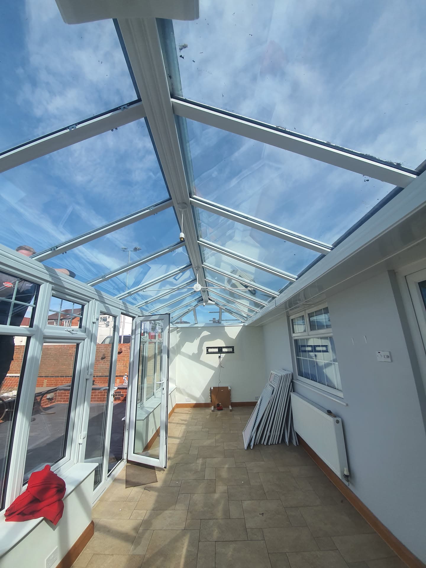 Interior view of conservatory with white uPVC frame and clear glass pitched roof panels