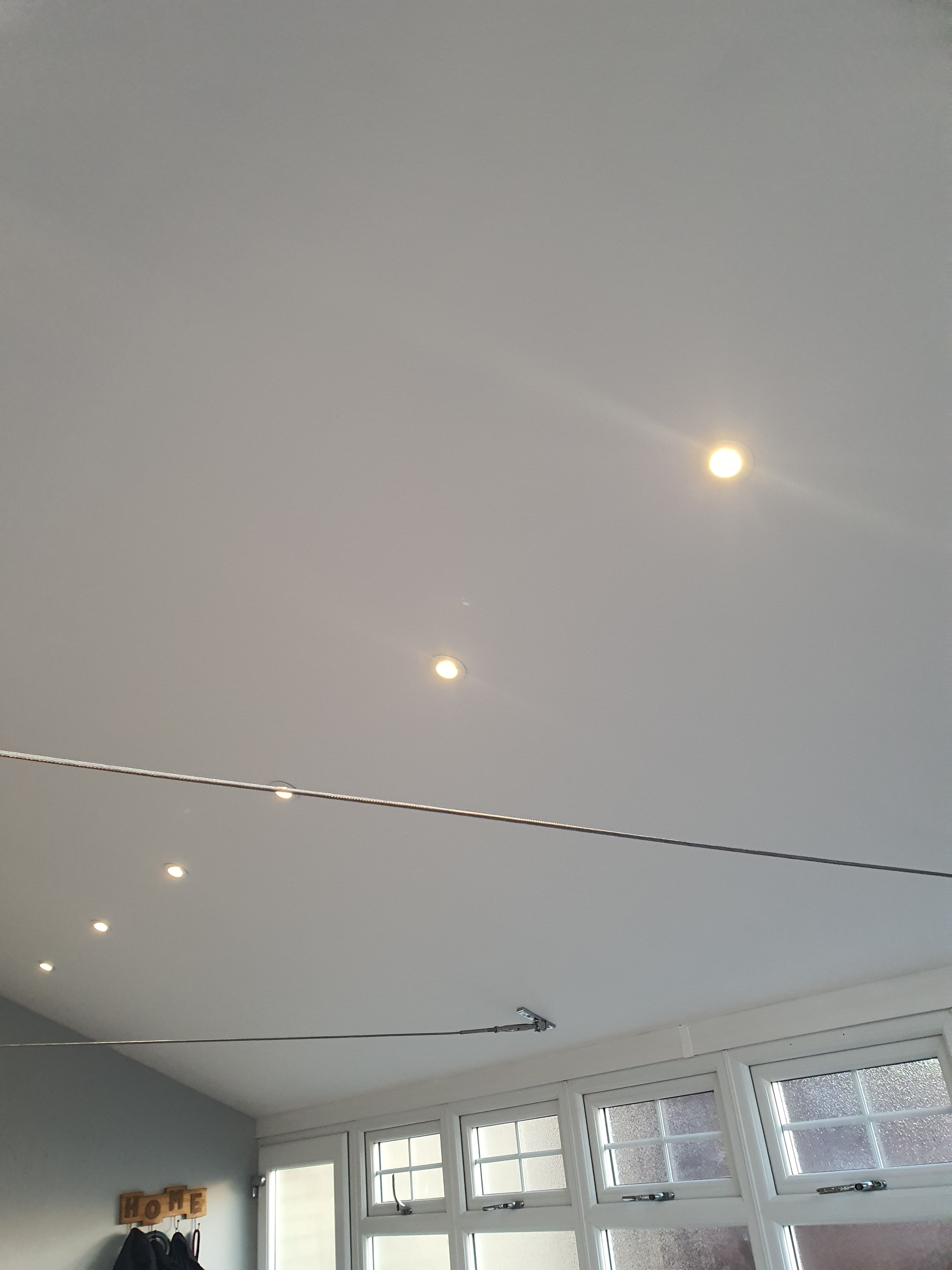 White conservatory roof interior with spotlights and glazed panels