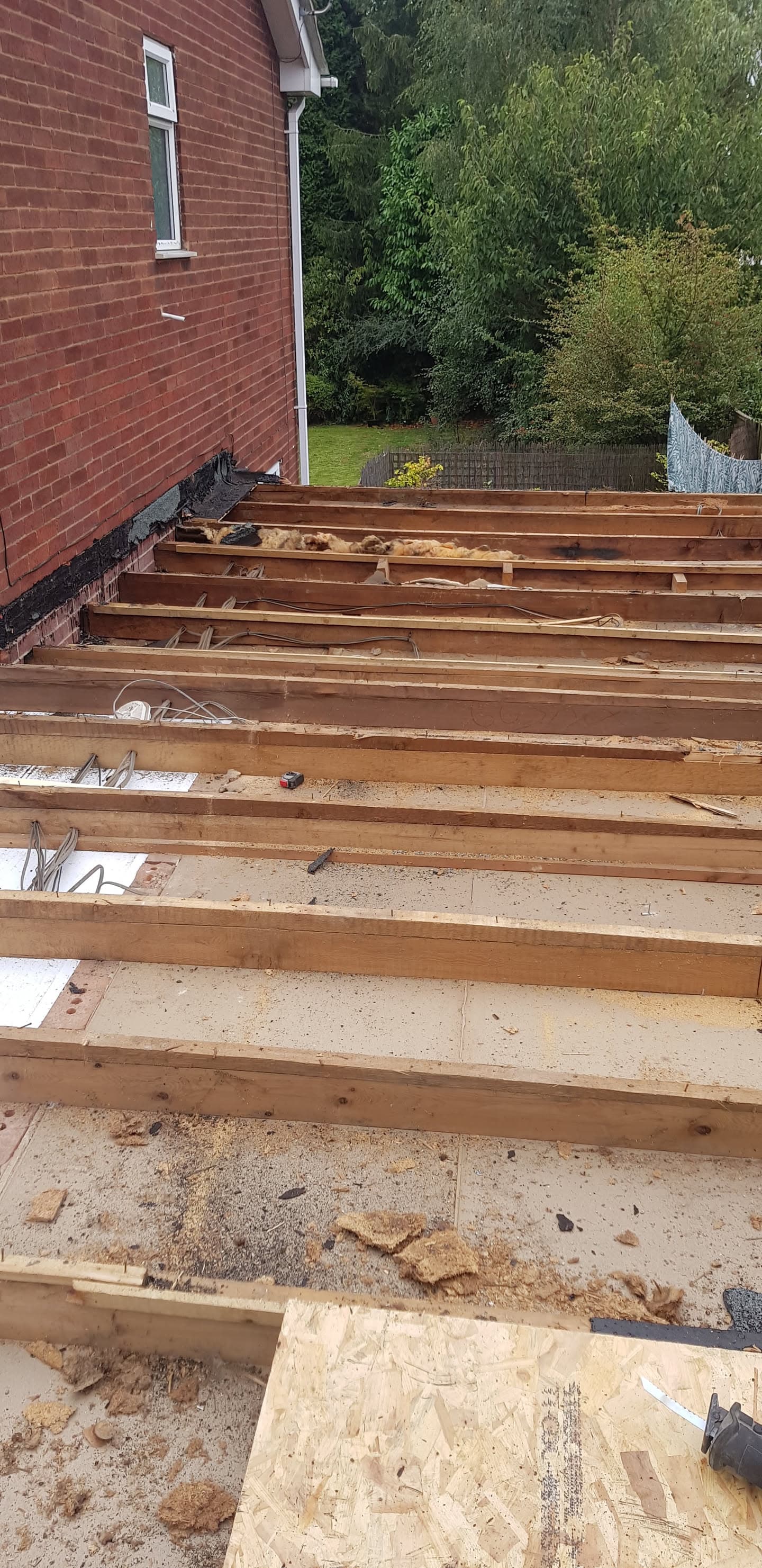 Timber joists and insulation boards laid on flat roof deck during construction