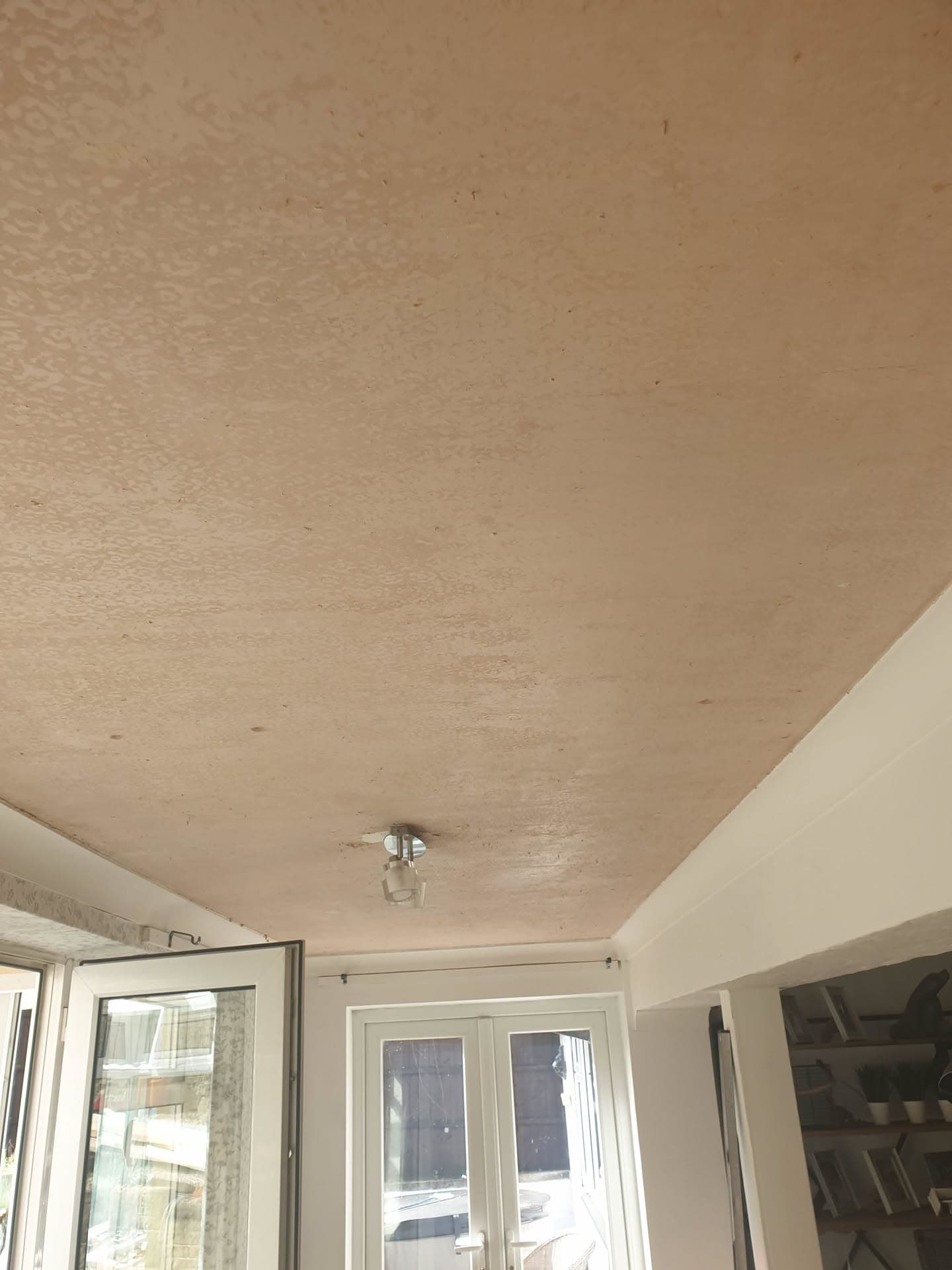 Interior view of conservatory ceiling with light-coloured plastered finish