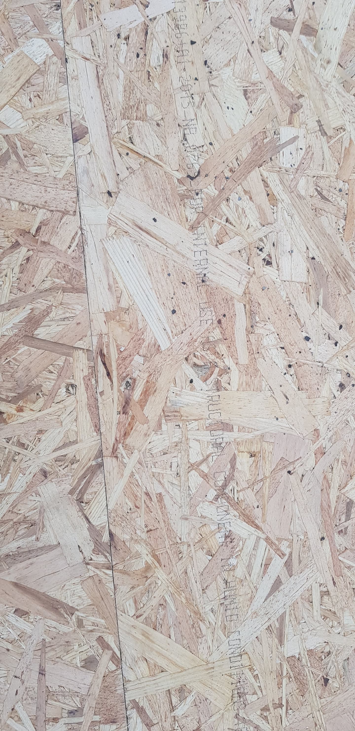 Oriented strand board (OSB) roof decking showing wood chip texture