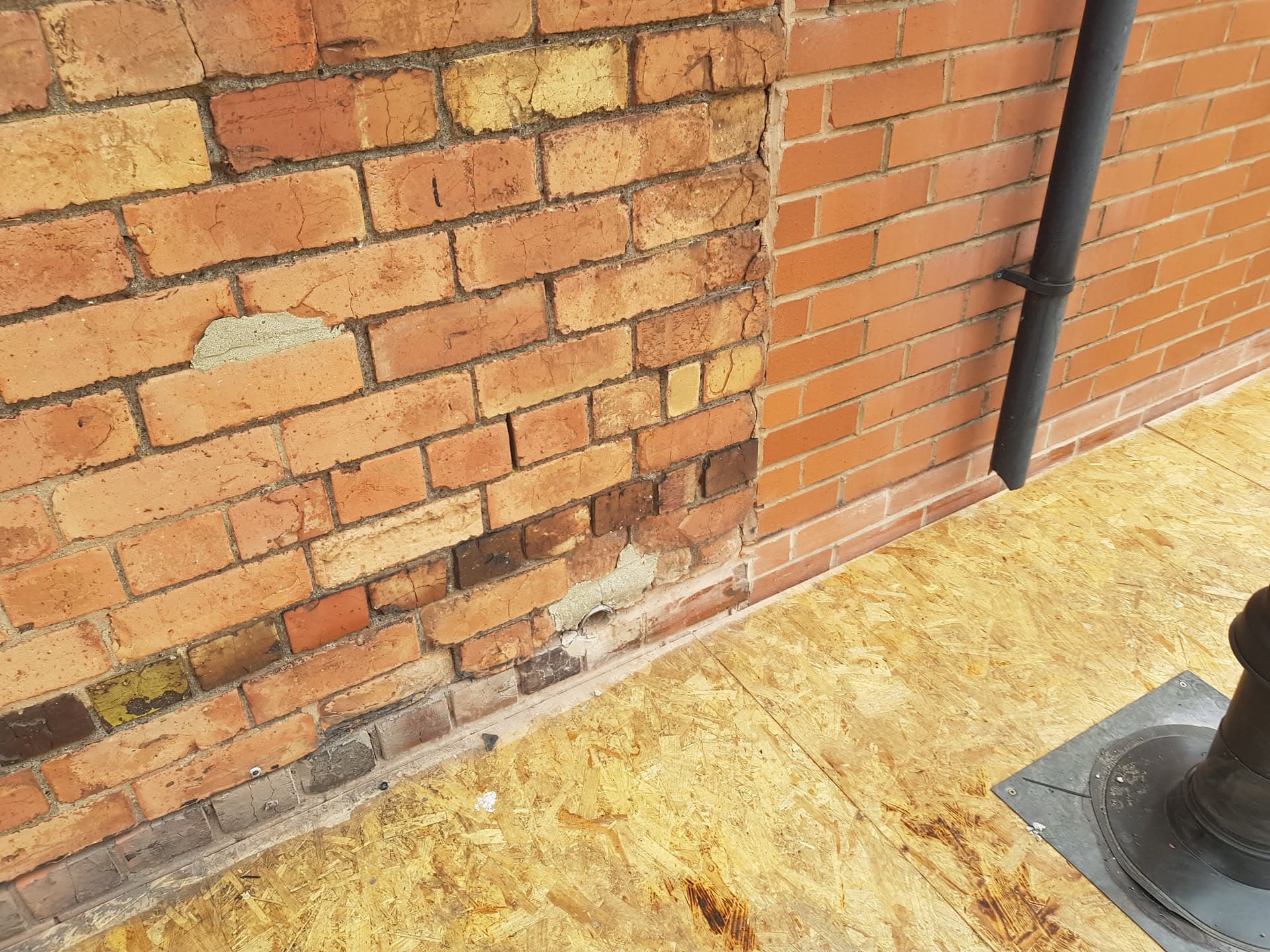 Flat roof with OSB boarding against brick chimney stack with lead flashing