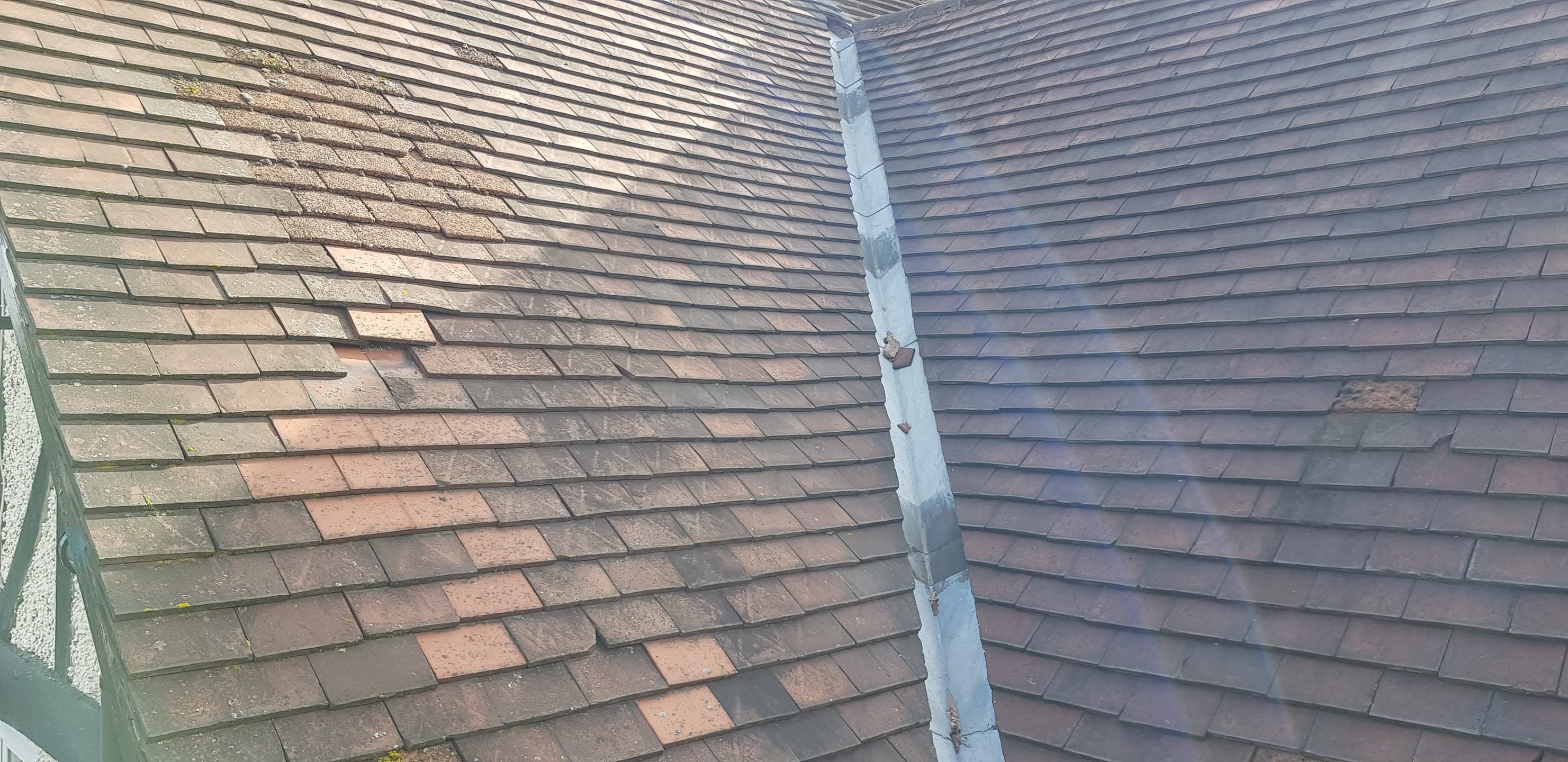 Pitched roof with concrete tiles meeting at valley with lead flashing