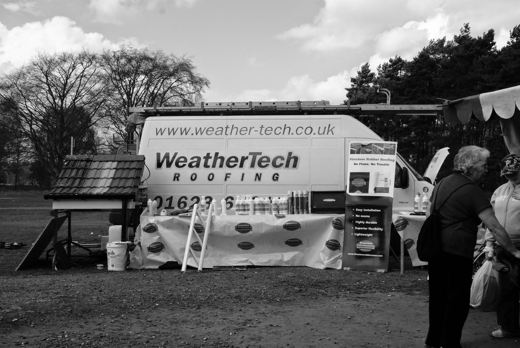 WeatherTech Roofing promotional display van with sample roof tiles and company branding at outdoor event