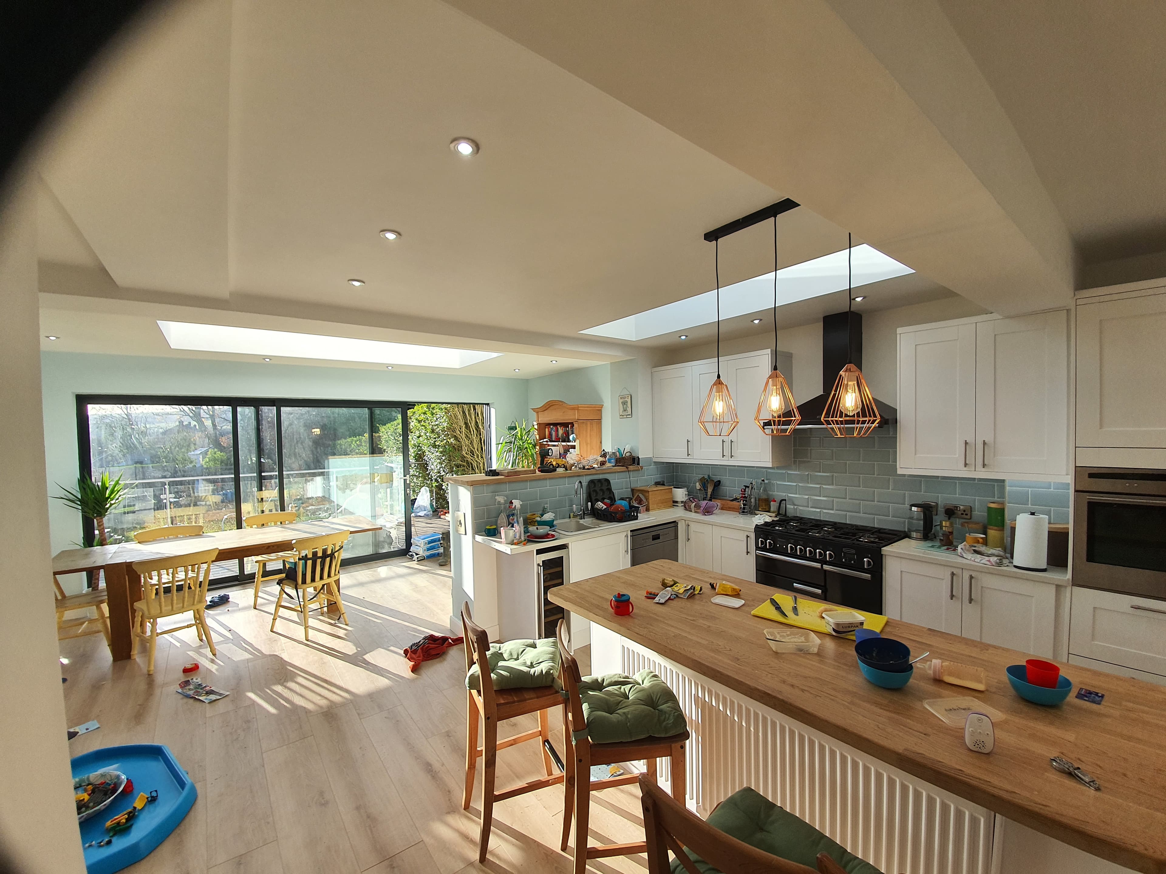 Kitchen extension with flat roof skylights allowing natural light into open-plan dining area