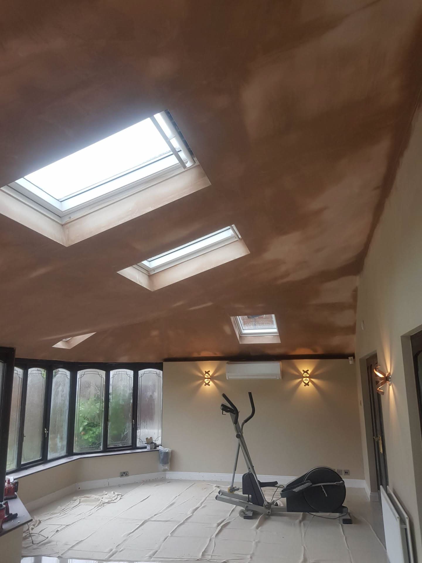 Interior view of pitched roof with three Velux skylights installed in vaulted ceiling